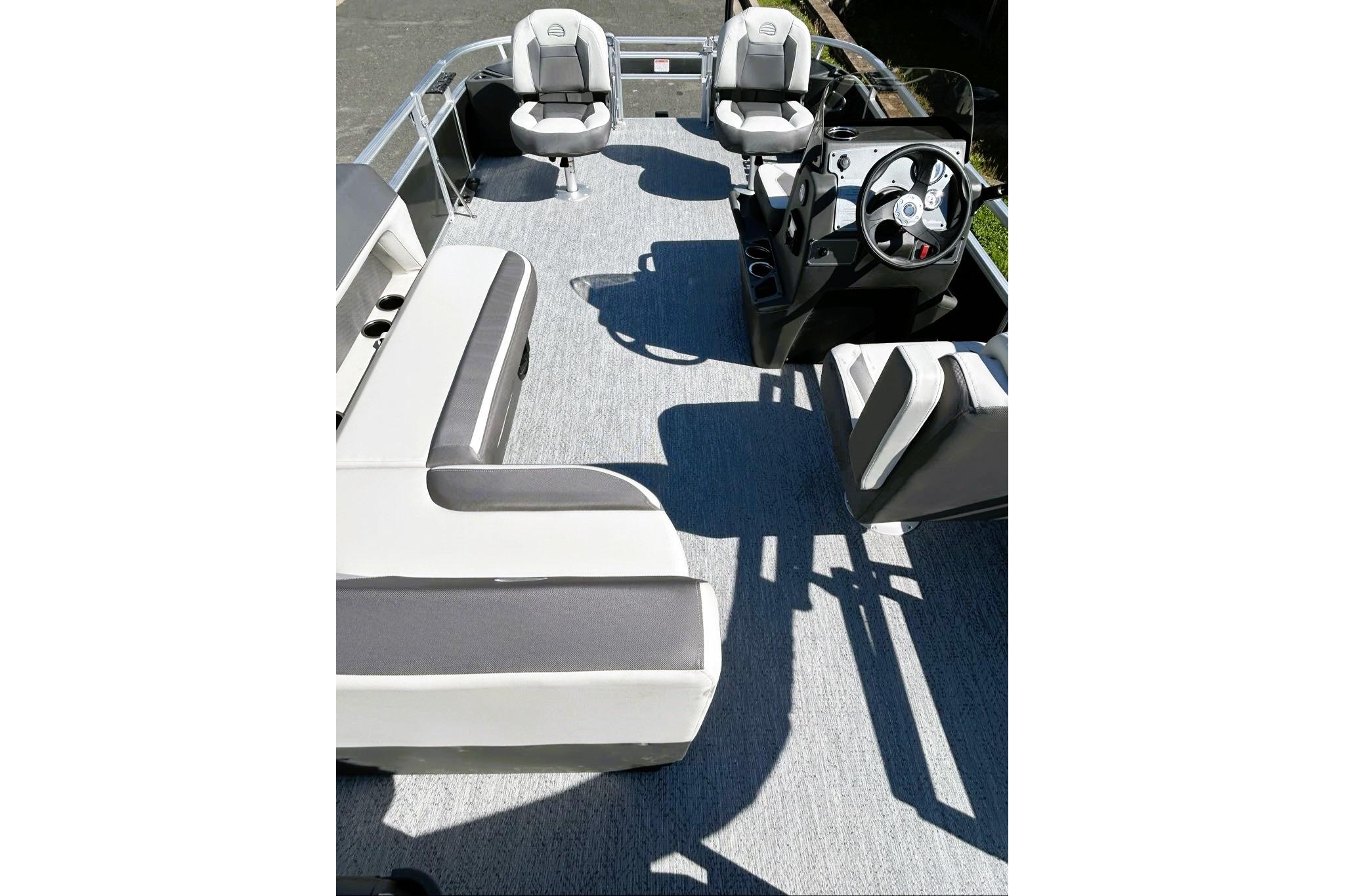 2026 Sun Tracker Bass Buggy 18 DLX pontoon boat interior with seating and steering console.
