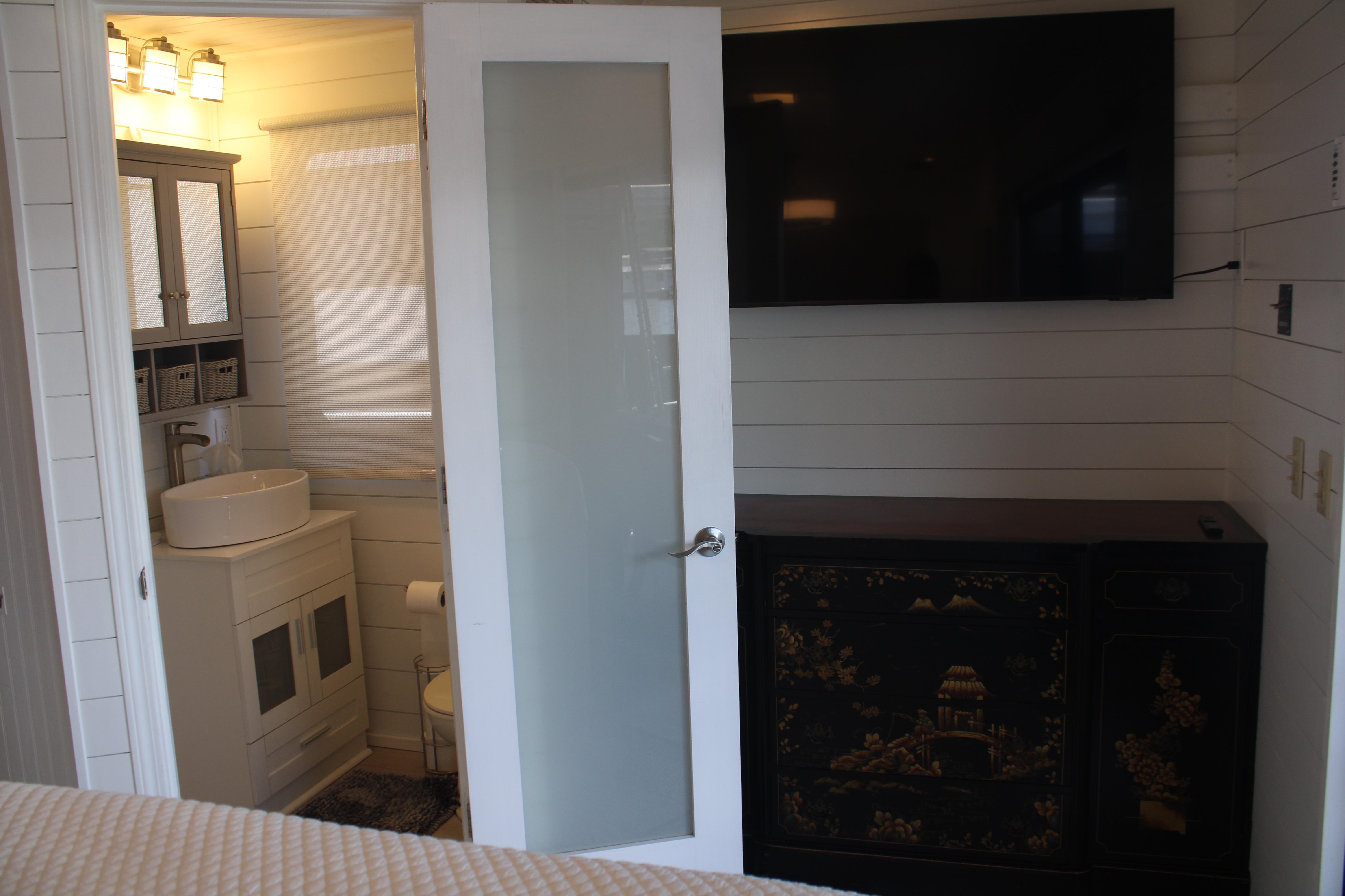 Interior of 1992 Sumerset 66 houseboat with modern bathroom and decorative cabinet.