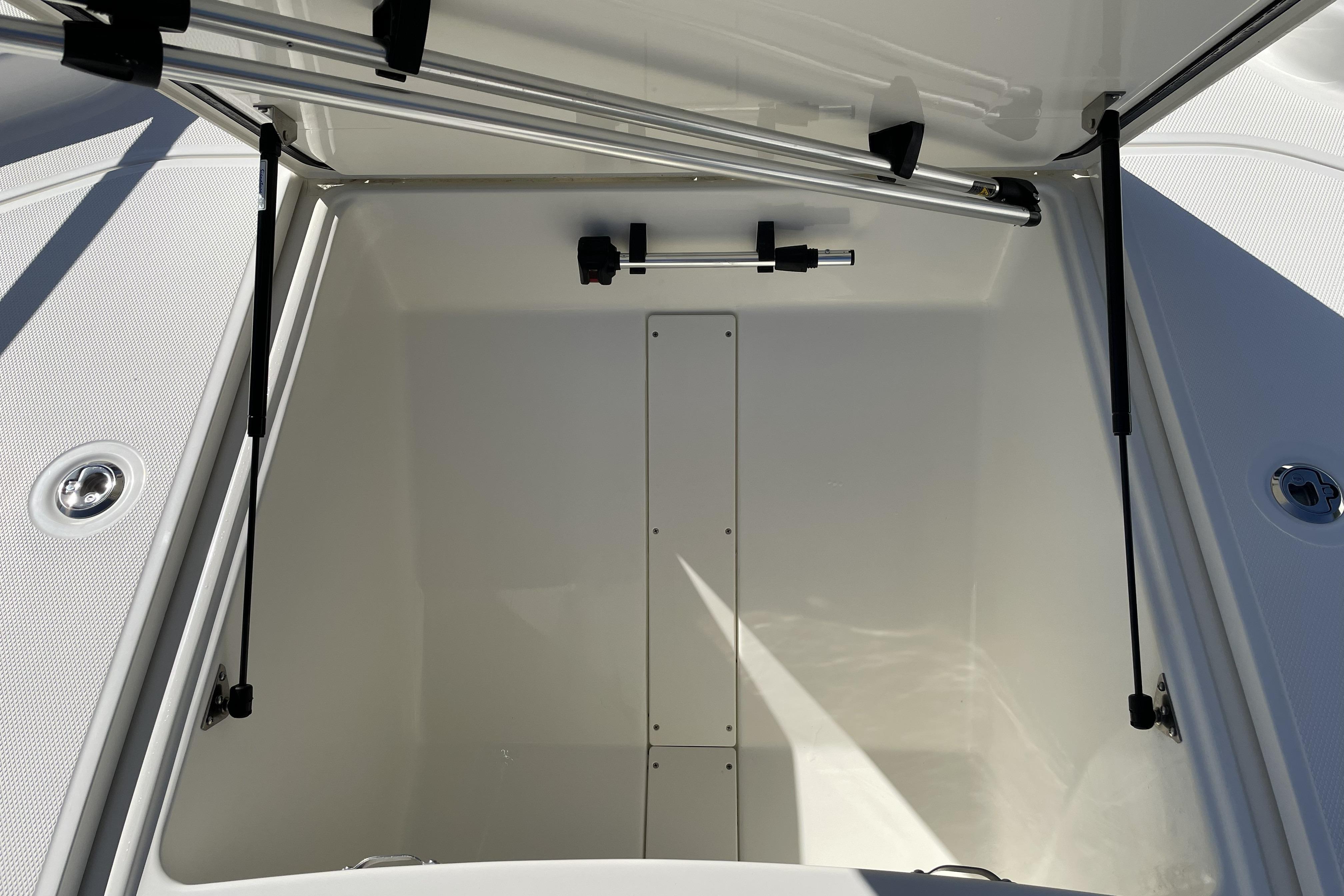 Open storage compartment of 2026 Mako Pro Skiff 19 CC boat.
