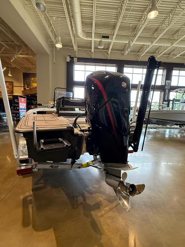 2025 Mako 18 Pro Skiff Backwater Edition in showroom, rear view with motor and propeller.