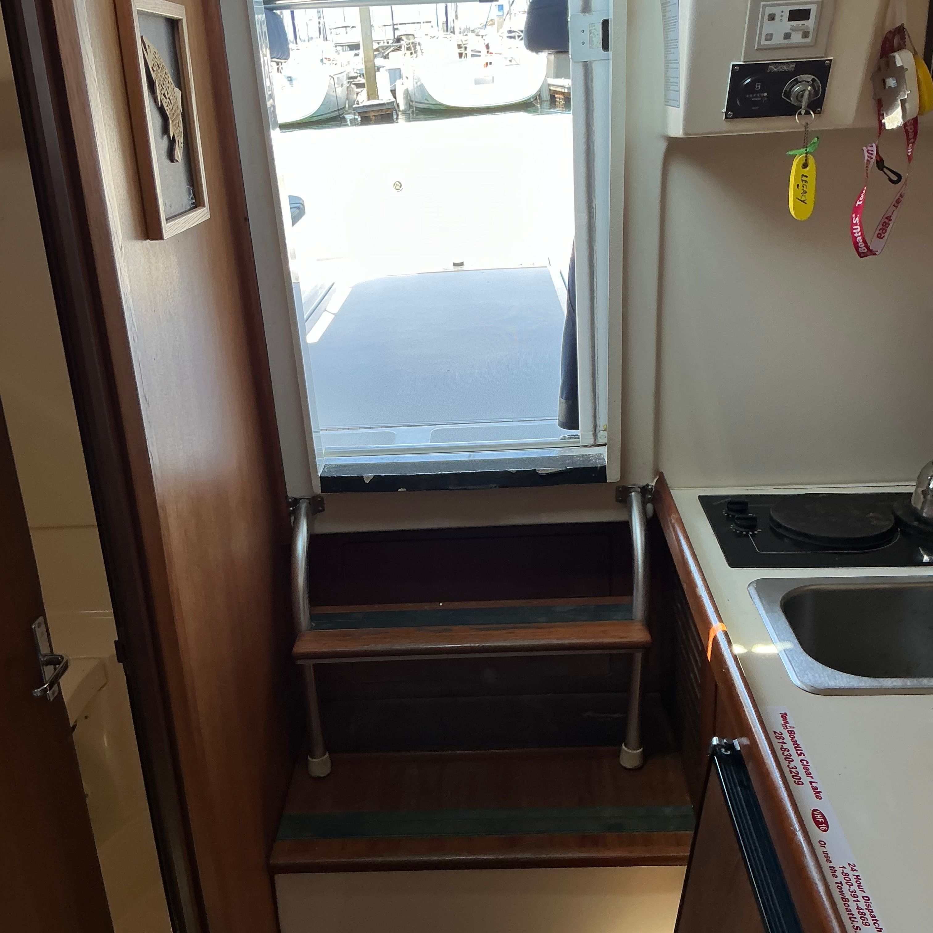 Interior of a 1999 Mainship Pilot 30 with stairs and kitchenette.