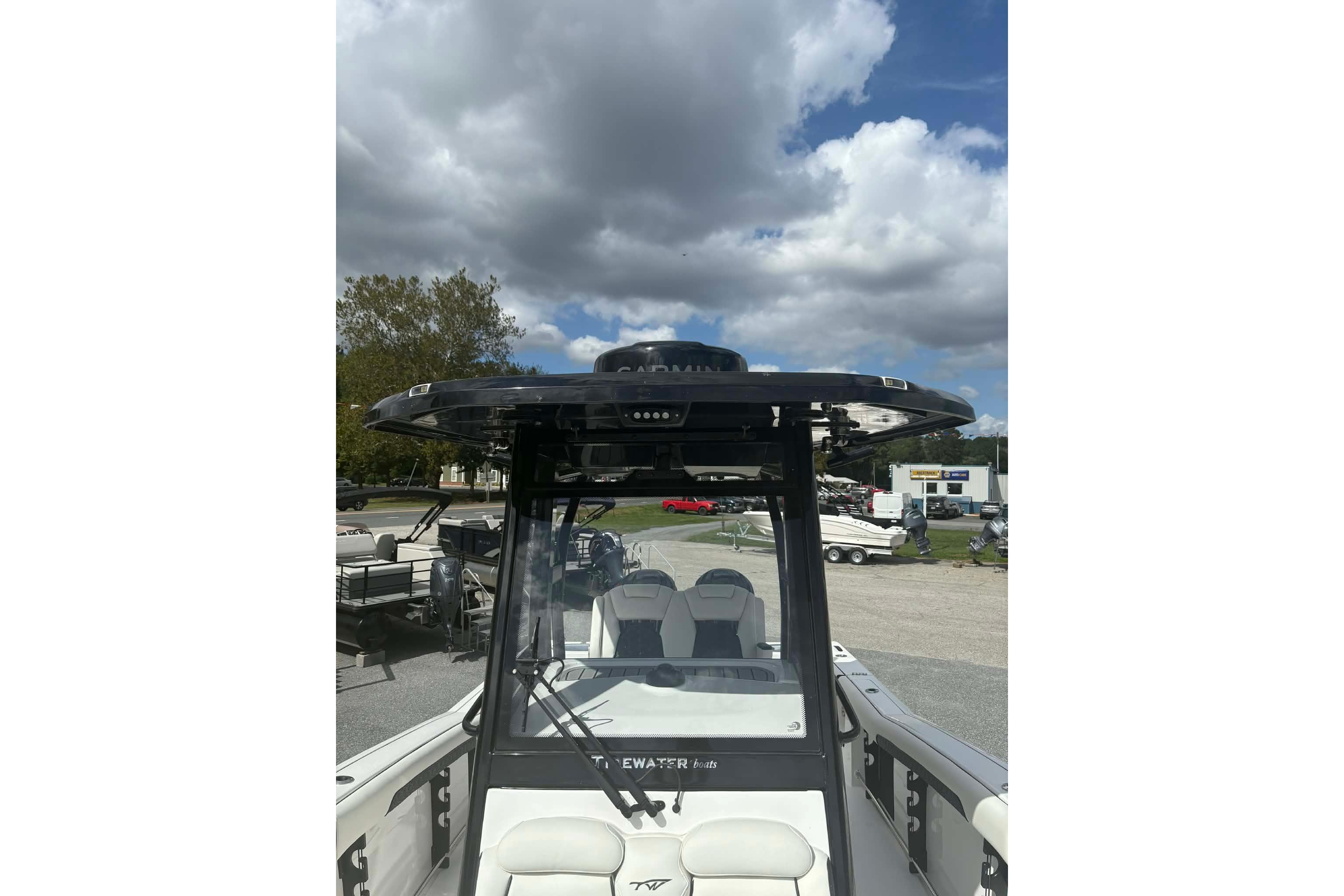 2026 Tidewater 282 CC Adventure boat with T-top under cloudy sky.