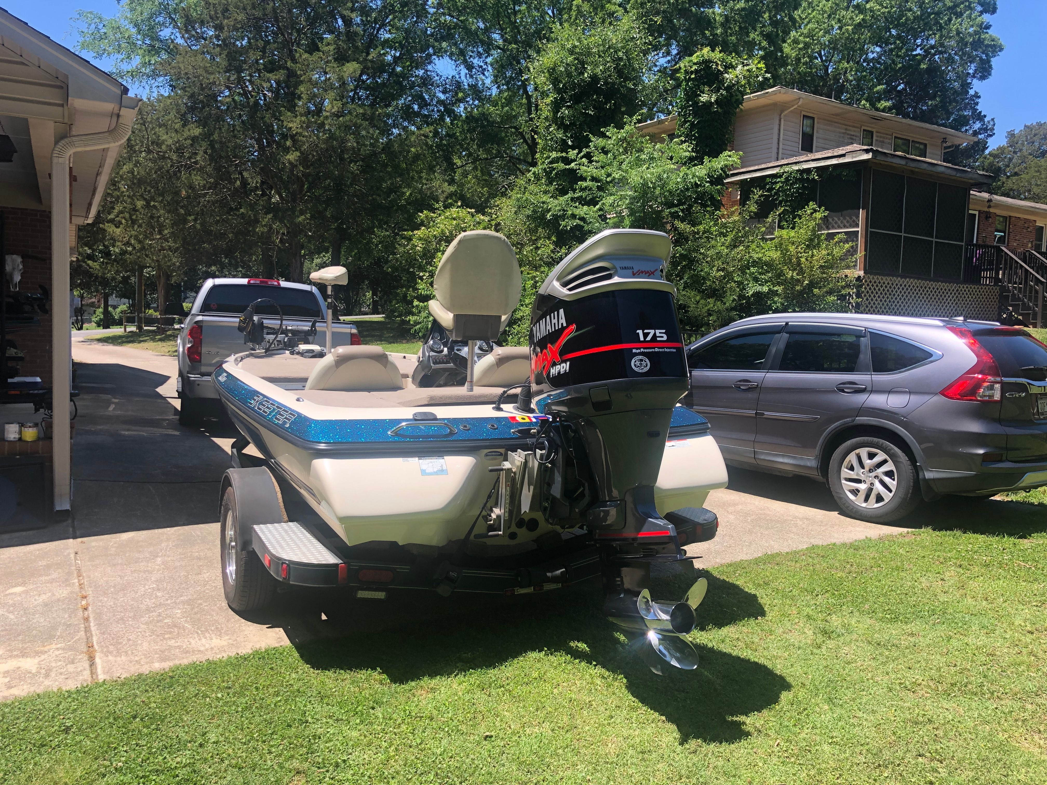 A 2012 Skeeter ZX190 boat on a trailer in a driveway.