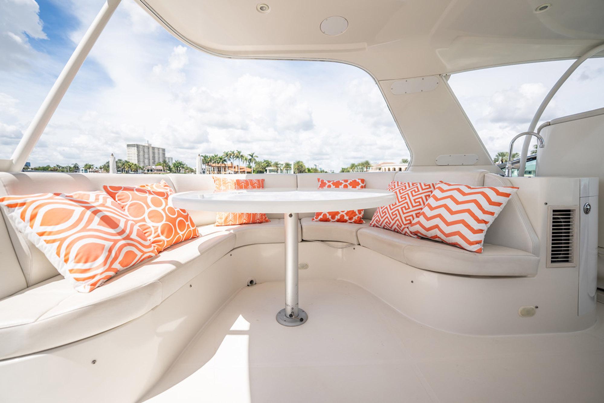 Luxurious 2005 Carver 56 Voyager yacht interior with vibrant orange-patterned cushions.