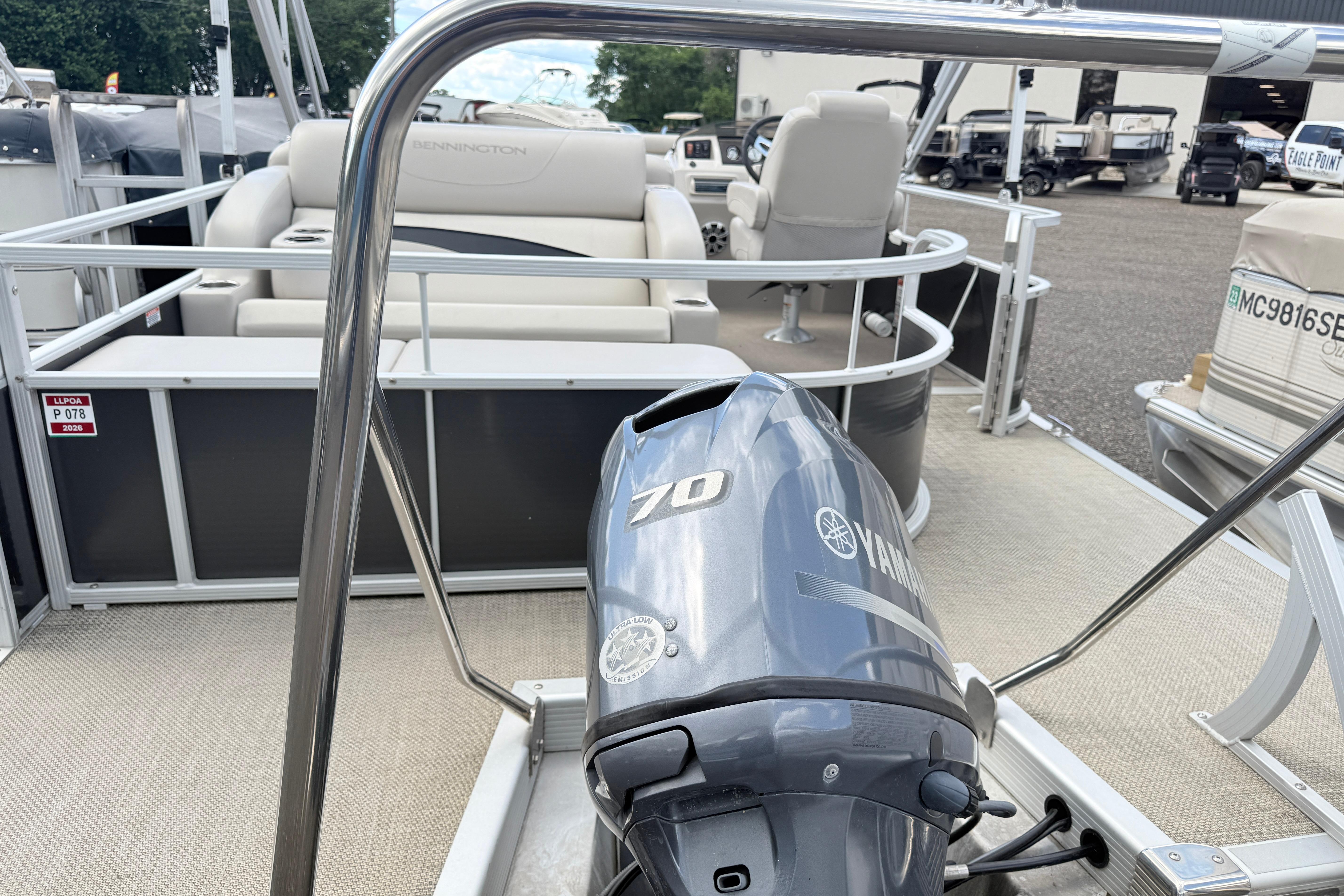 2015 Bennington 24SSLX pontoon boat with Yamaha 70 outboard motor, docked outdoors.
