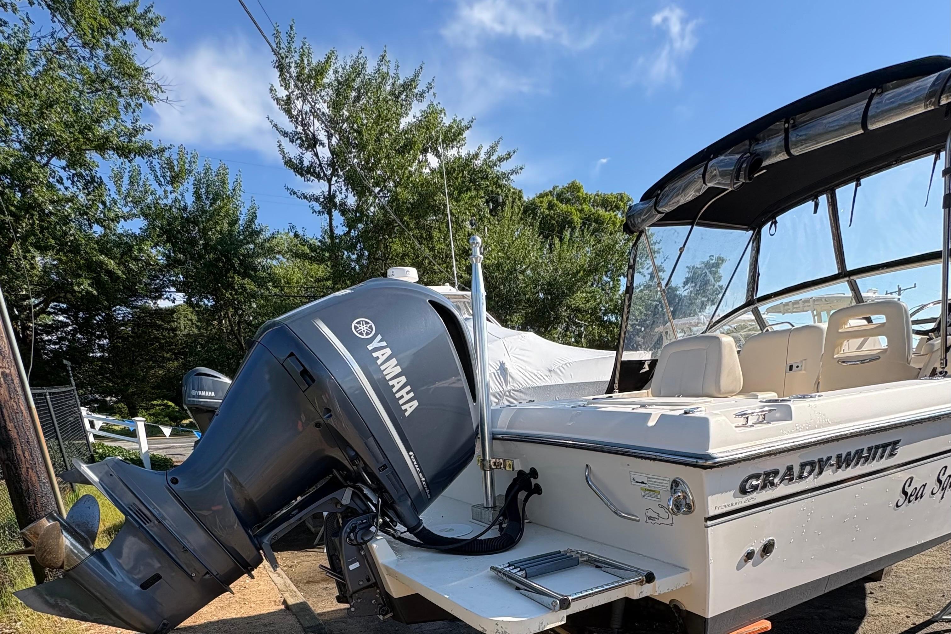 2015 Grady-White Freedom 225 boat with Yamaha outboard motor, parked outdoors.