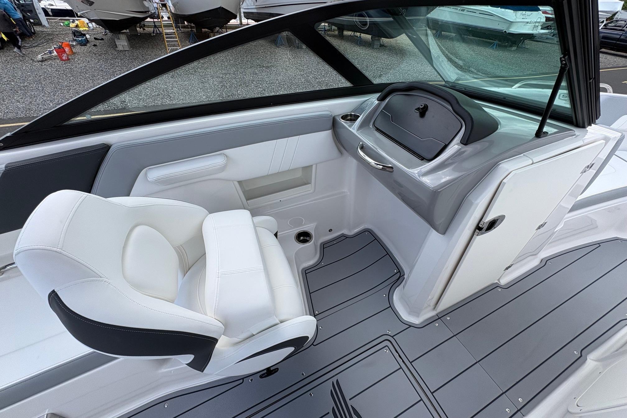 Interior view of 2026 Chaparral 23 SSi OB boat, featuring sleek seating and modern dashboard.