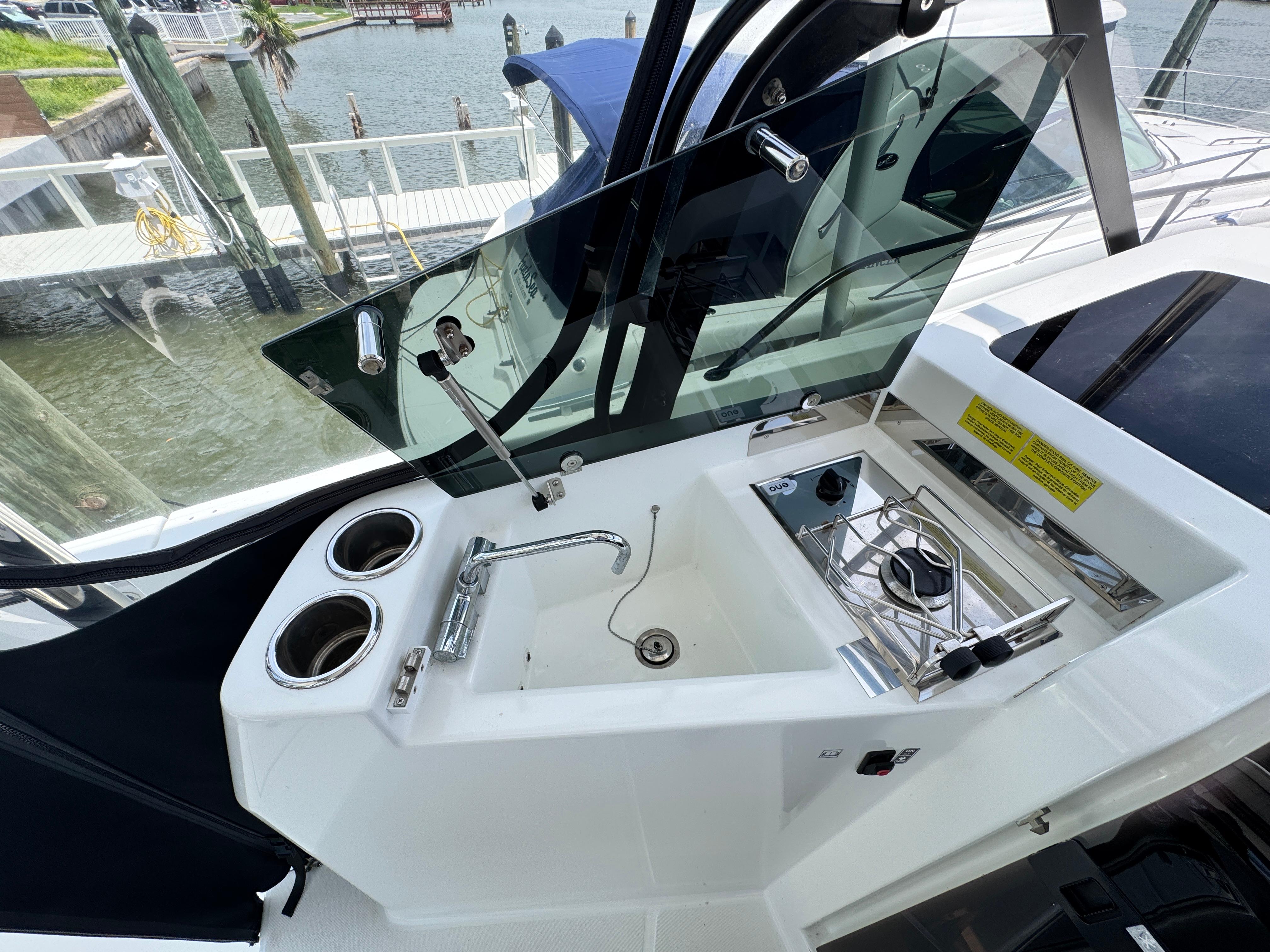 2022 Beneteau Flyer 9 SUNdeck boat kitchen area with sink and stove.