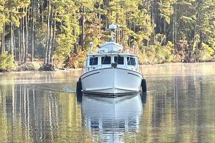 1997 Rosborough Trawler on serene lake with forest backdrop.