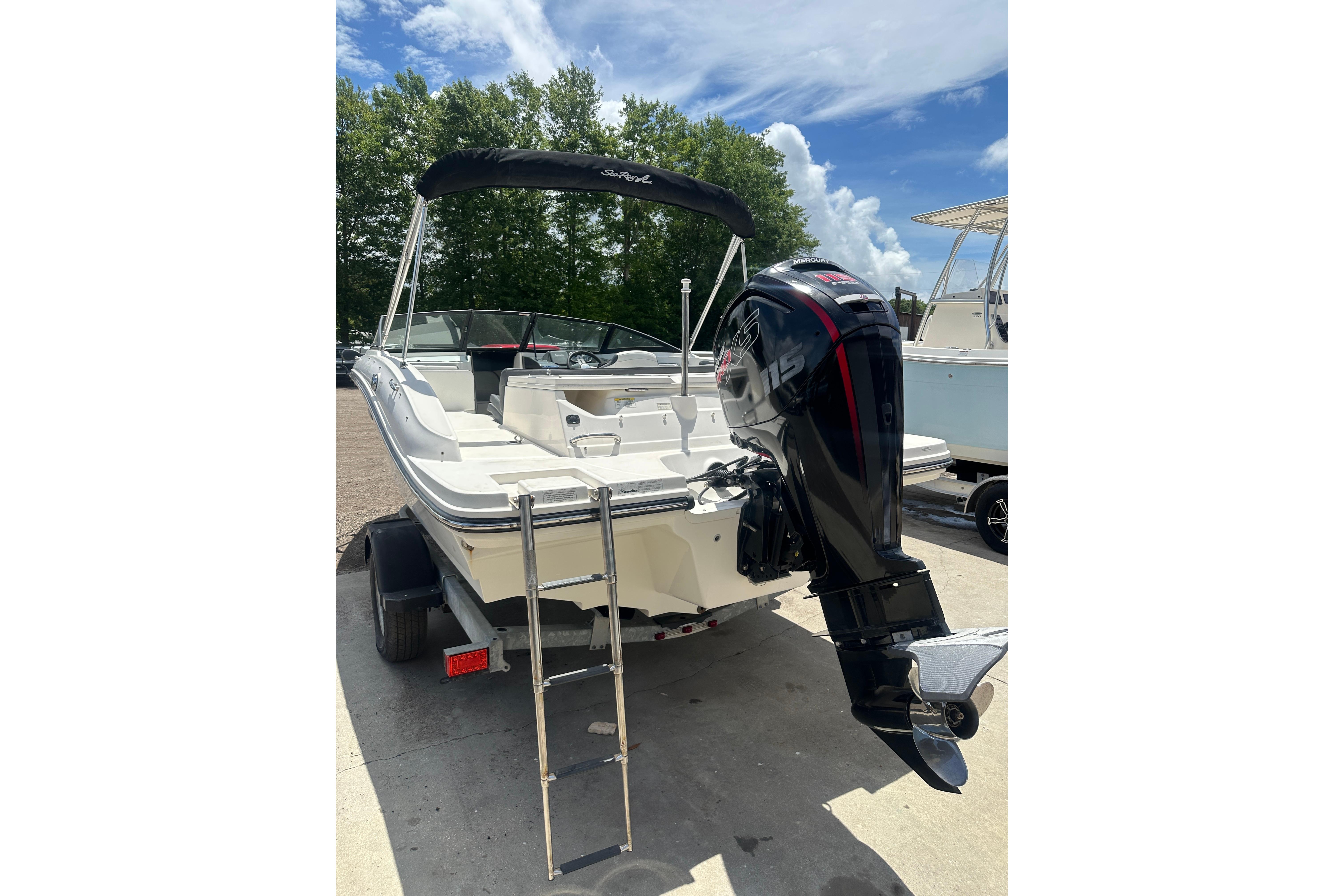 2017 Sea Ray SPX 190 Outboard boat with ladder and outboard motor, parked outdoors.