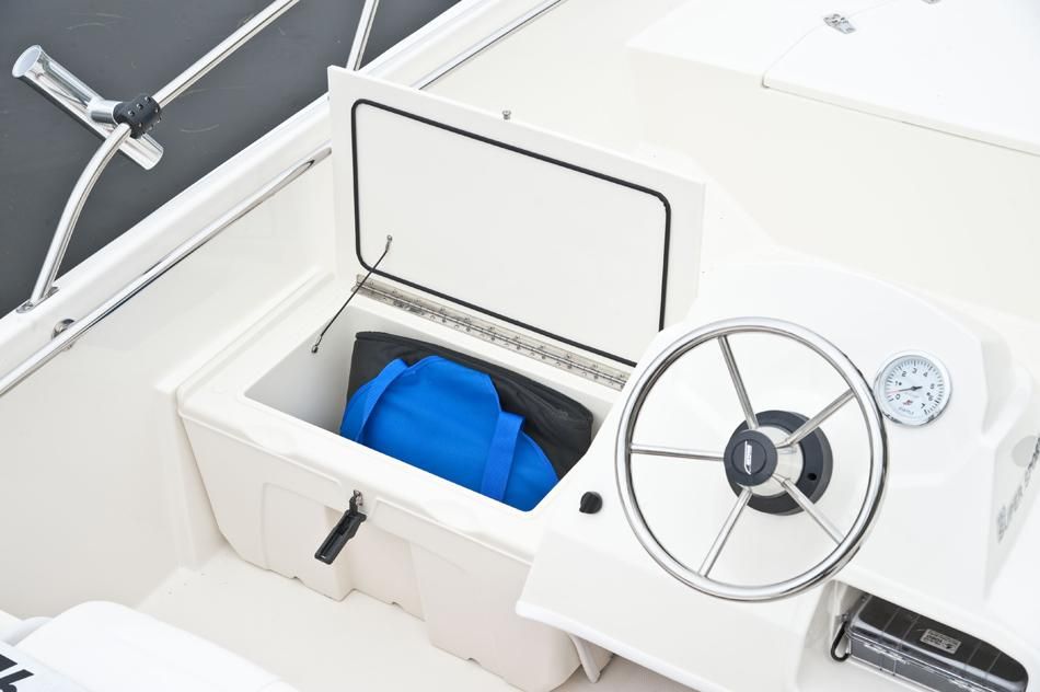 Boston Whaler 150 Super Sport 2018 helm with storage compartment.