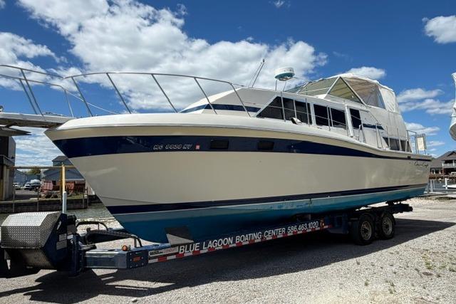 1980 Chris-Craft 381 Catalina boat on trailer under blue sky.