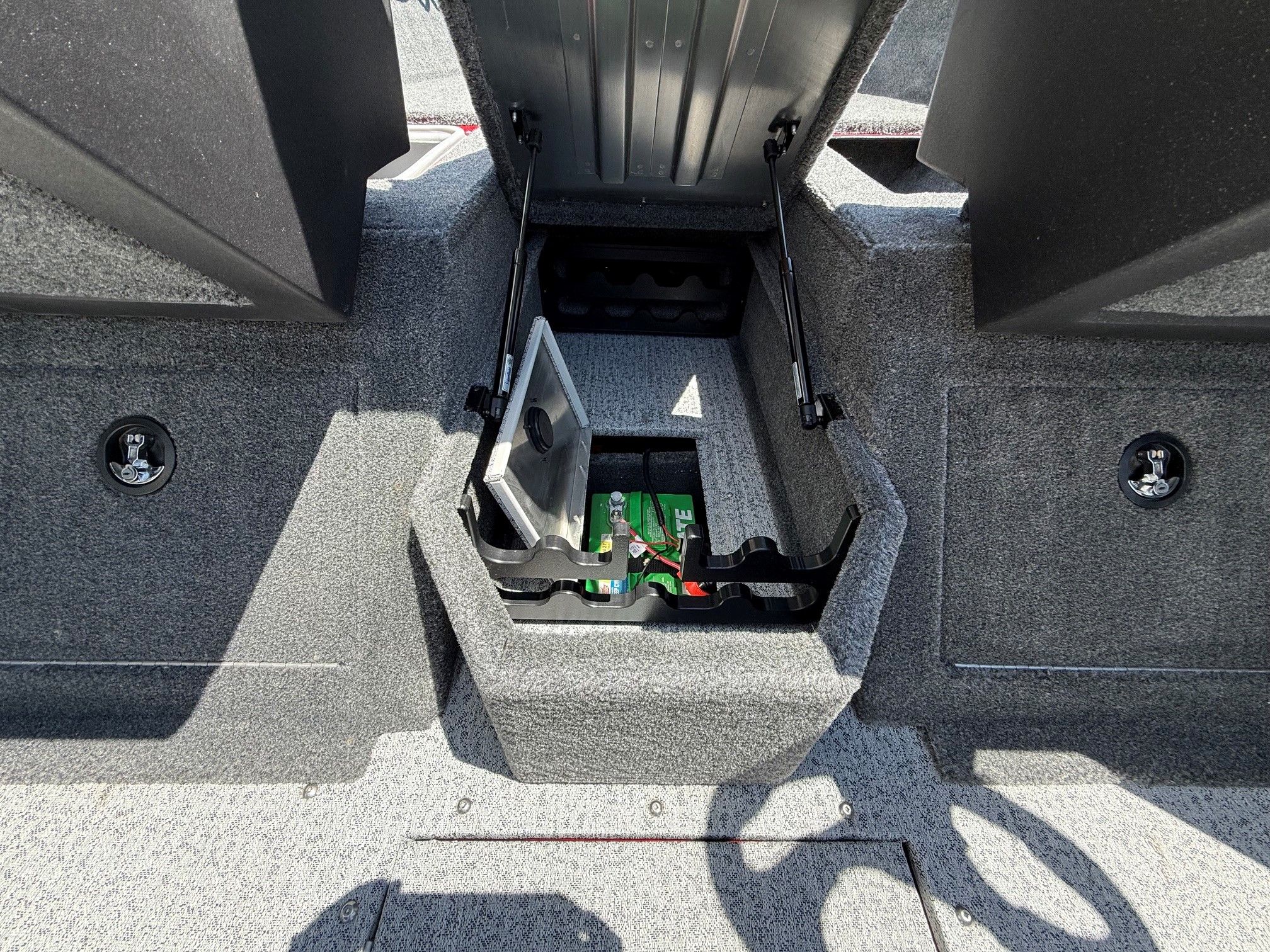 Tracker Pro Guide V175 2024, open storage compartment with battery.