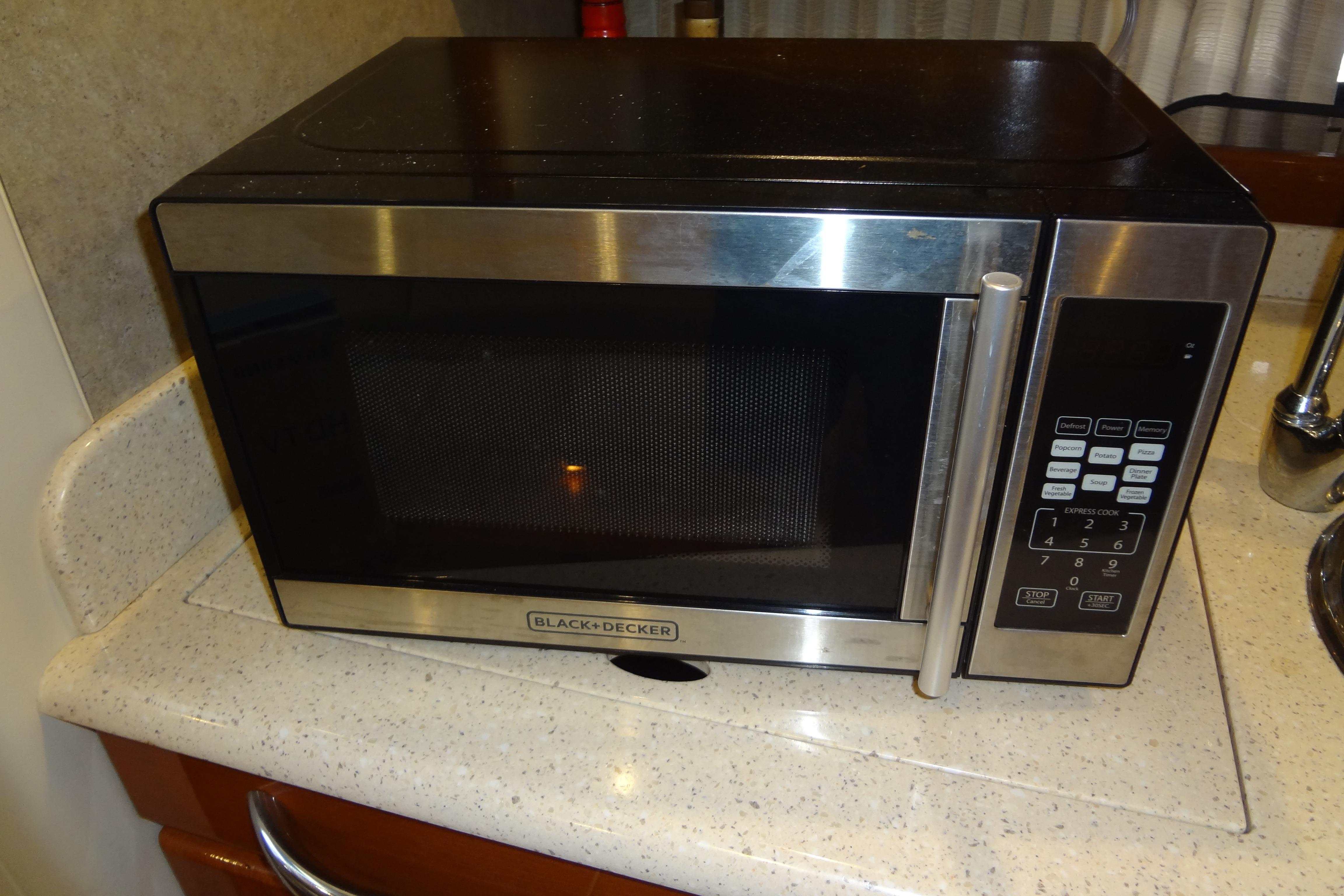 Black and Decker microwave on a speckled countertop in a 2007 Formula 34 Performance Cruiser.