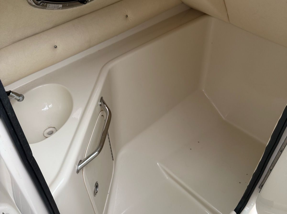Interior of the 2007 Sea Ray 240 Sundeck with a sink and storage area.