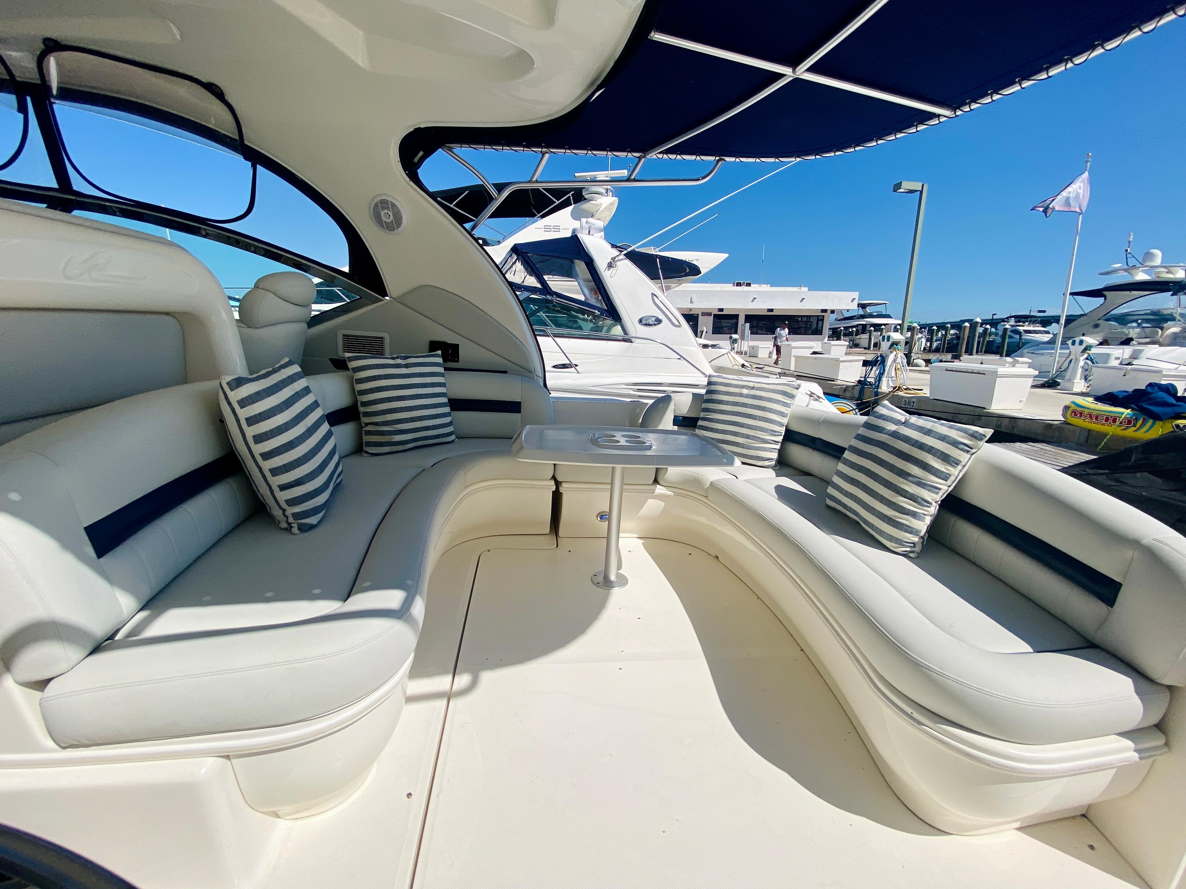 2007 Sea Ray 44 Sundancer yacht with spacious seating area and striped cushions.