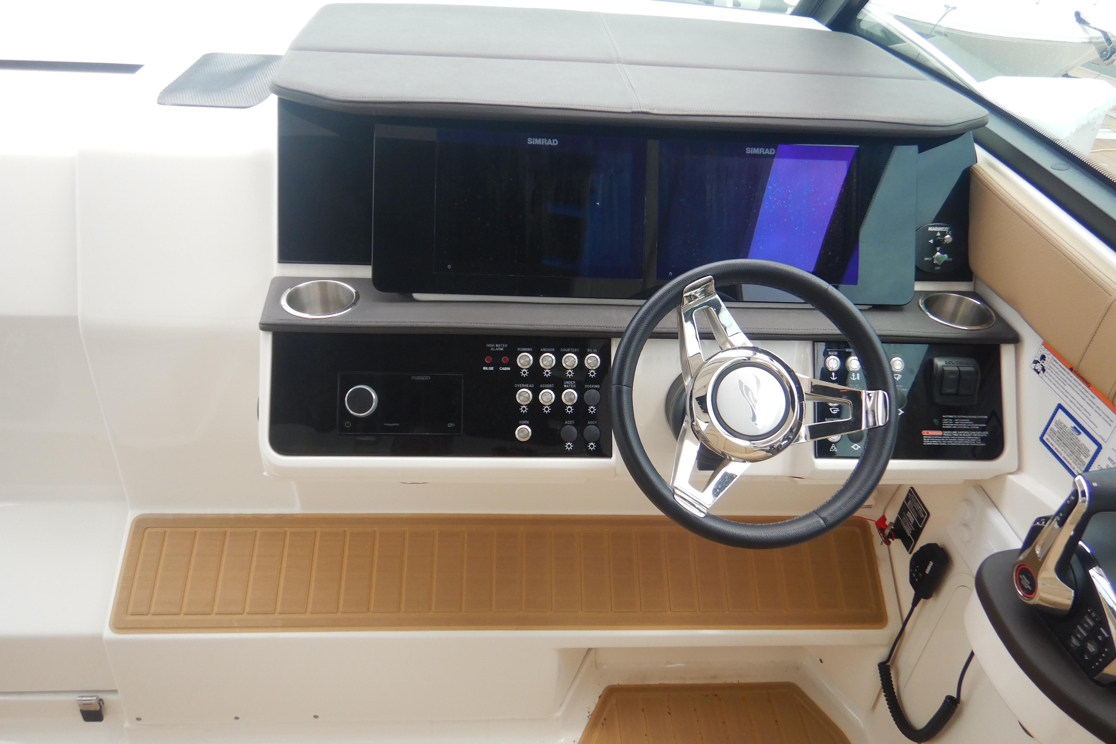 2023 Sea Ray Sundancer 320 helm with modern controls and steering wheel.
