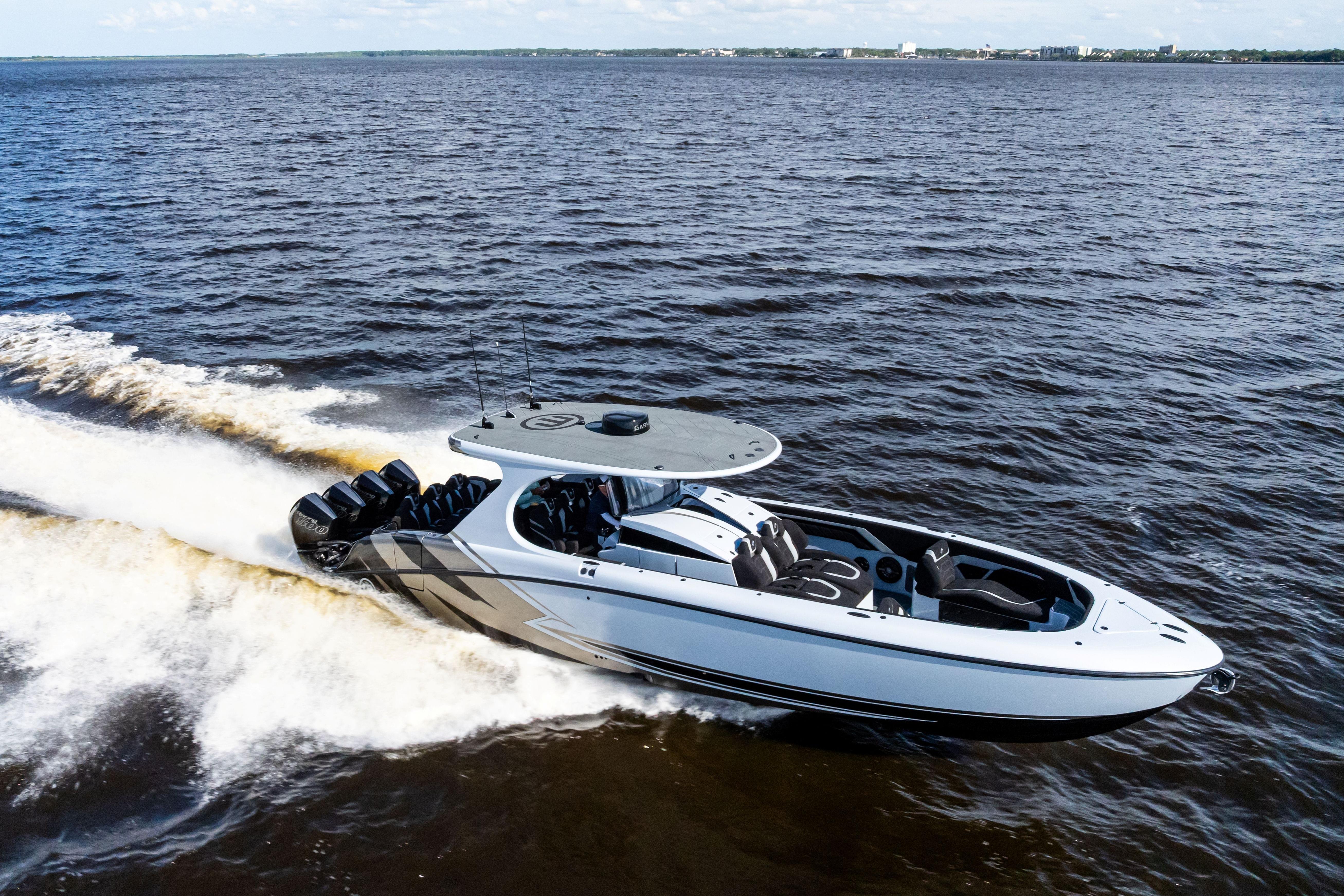 2027 Mystic Powerboats M4200 speeding on open water, showcasing sleek design and powerful engines.