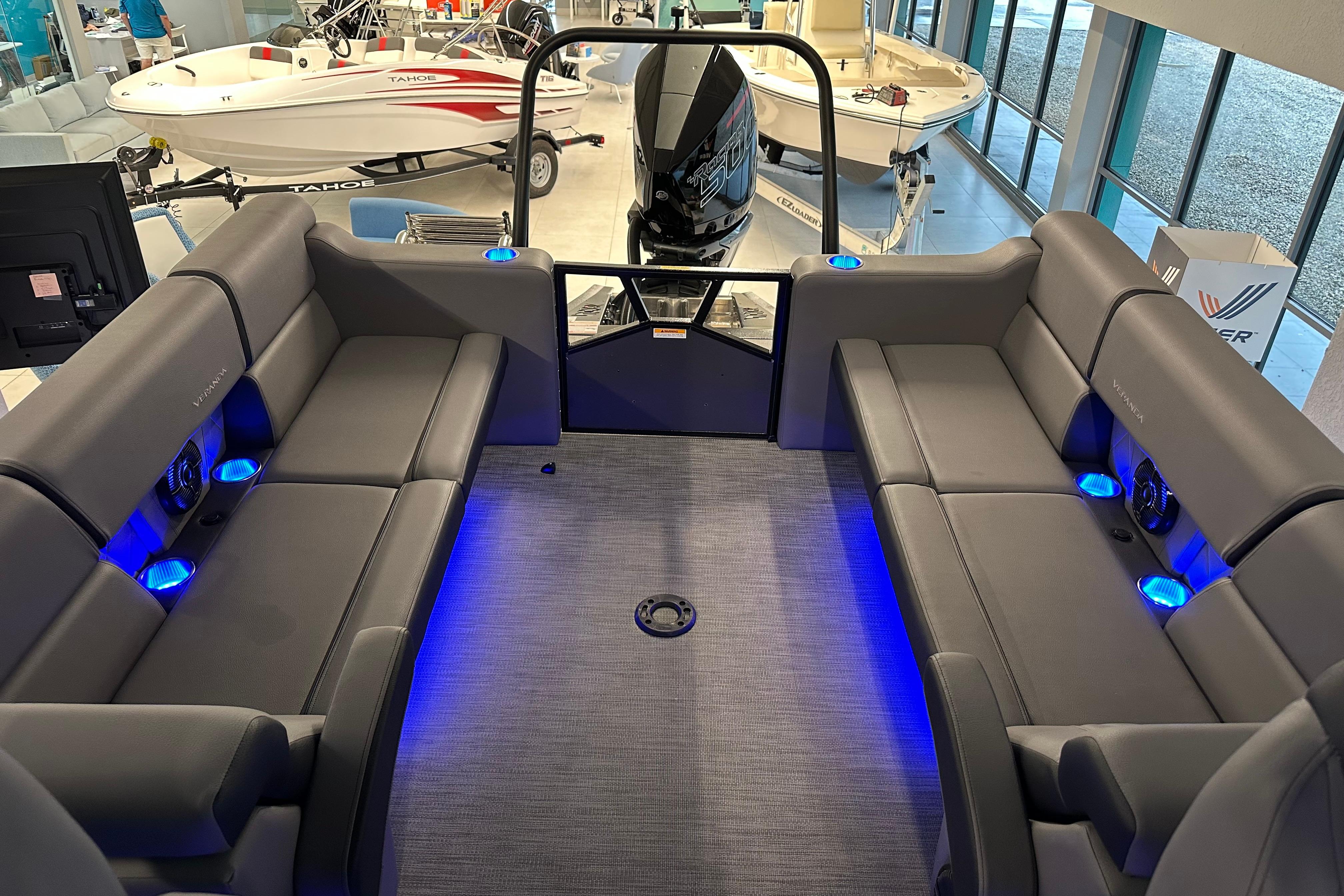 Luxurious interior of 2025 Veranda VX 27 DCRC pontoon boat with blue LED lighting.