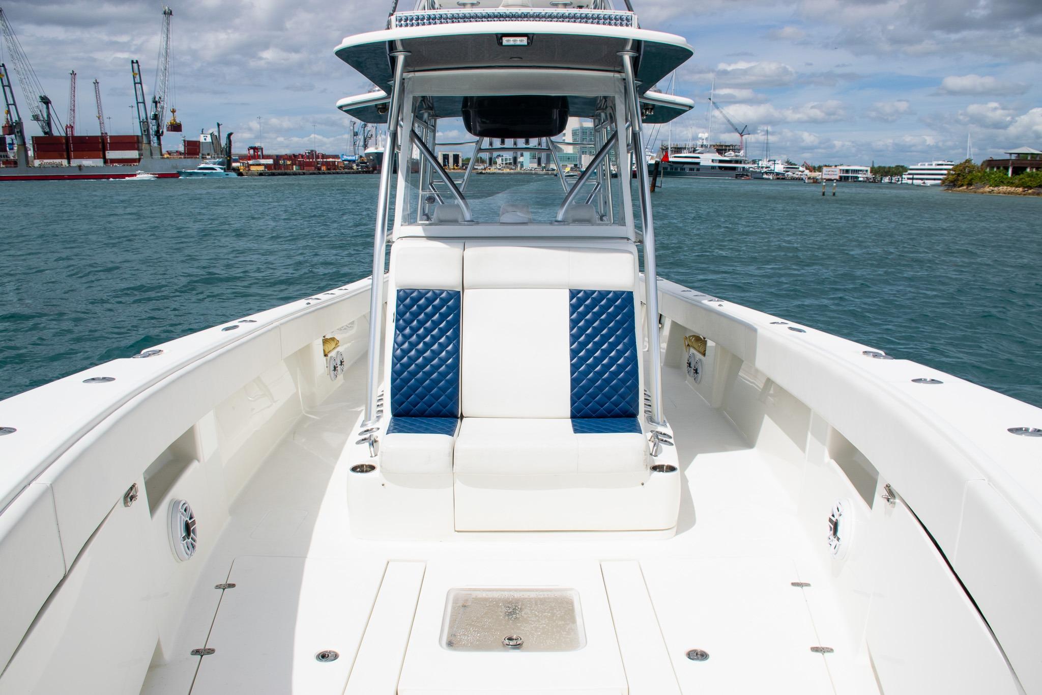 2022 SeaVee 390Z boat with blue and white seating, docked in a harbor.