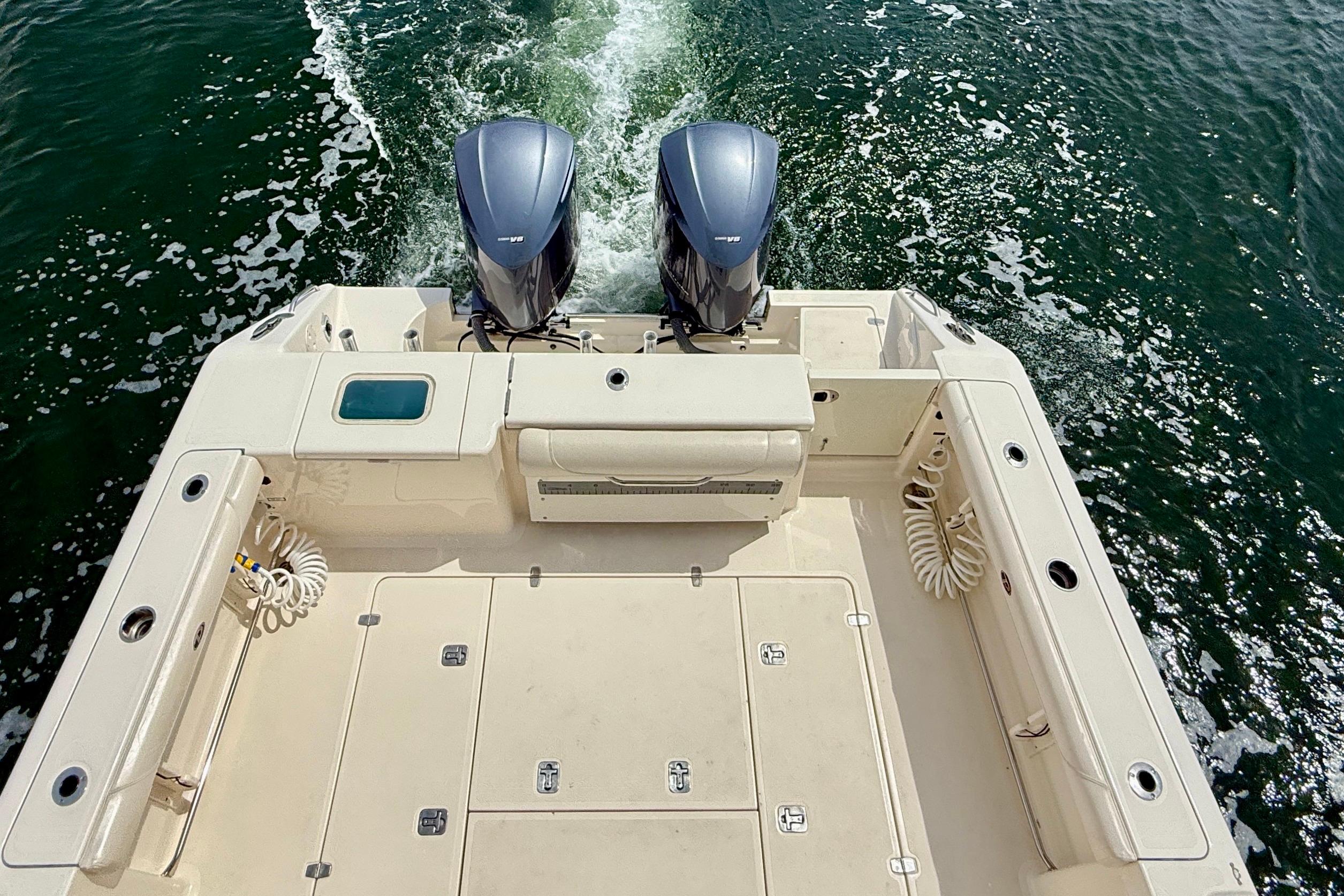 2012 Pursuit OS 345 Offshore boat with dual engines cruising on water.