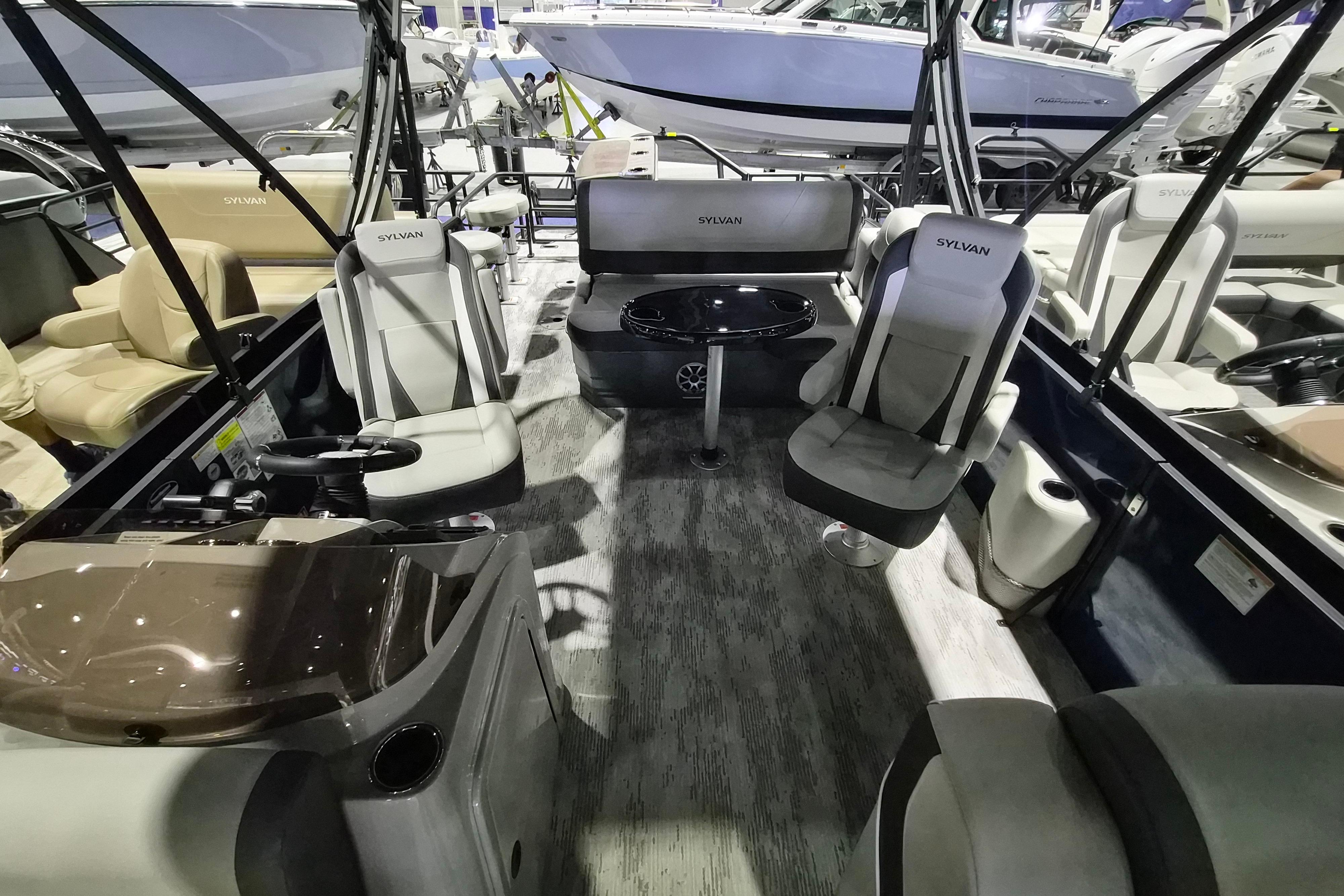 Interior of 2026 Sylvan R-22 LZ DH pontoon boat with modern seating and table.