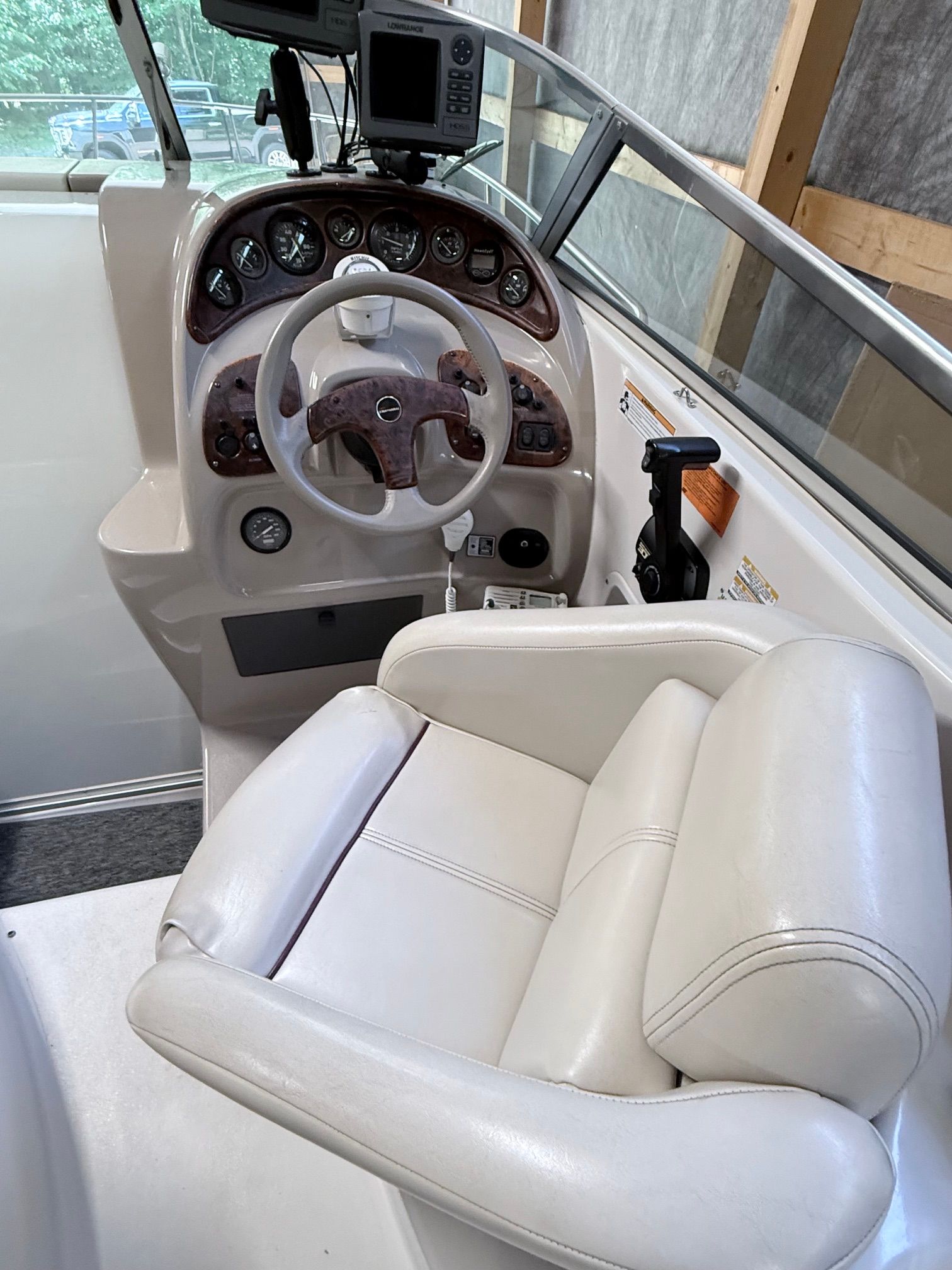 The image shows the cockpit of a 1997 Chaparral Signature 260 with a white leather seat.