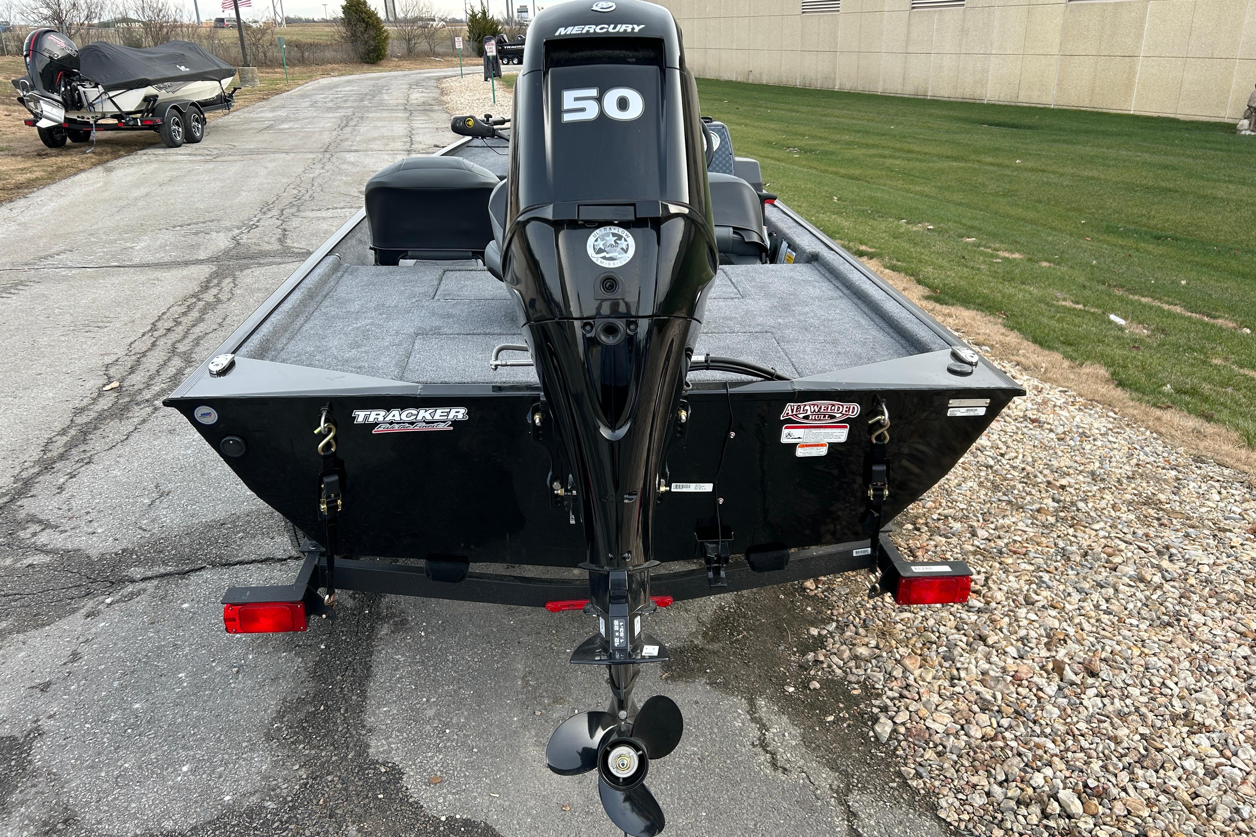 2026 Tracker Bass Tracker Classic XL boat with Mercury 50 engine, parked on pavement.