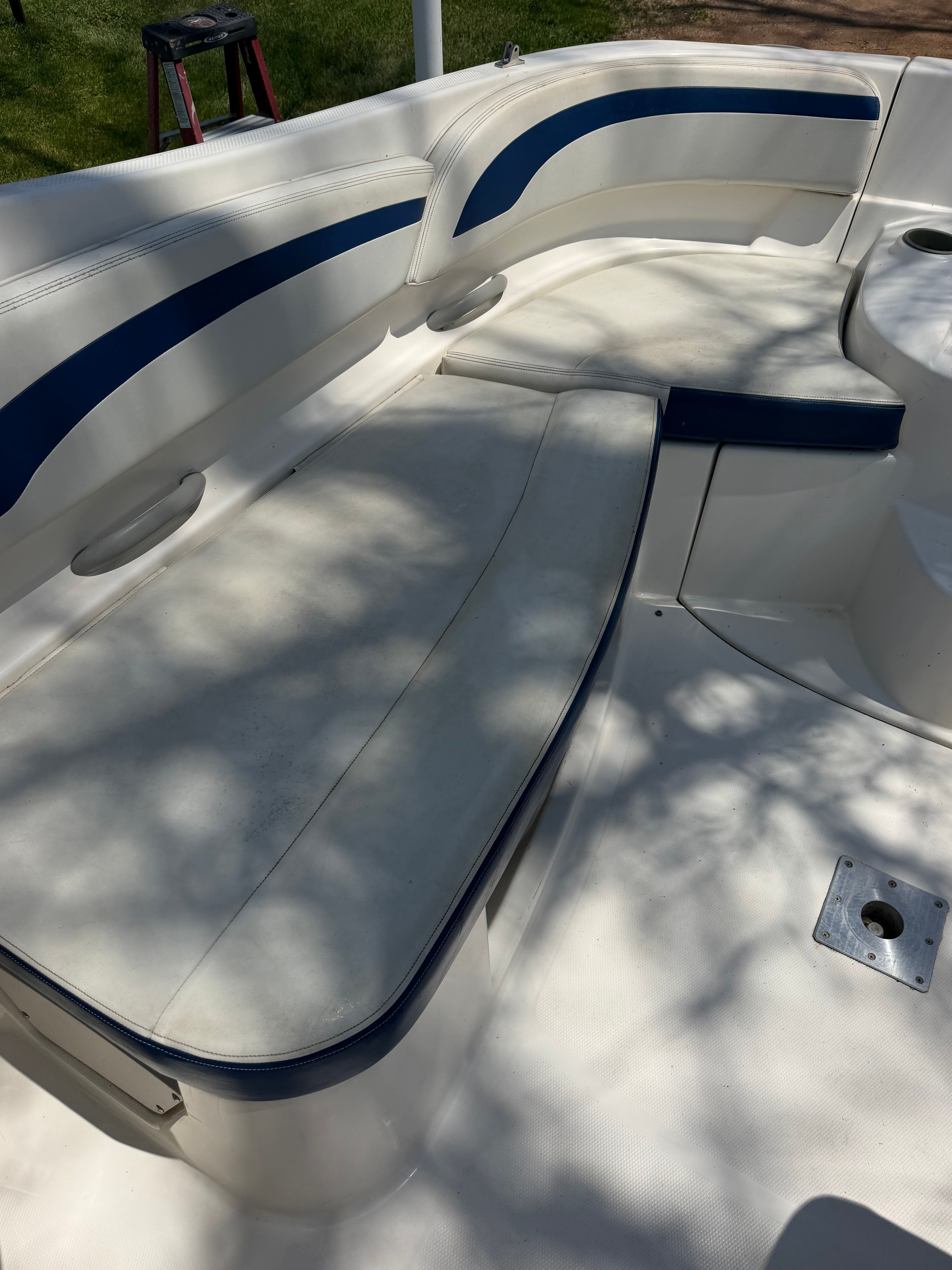 The image shows the seating area of a 2005 Bayliner 212 open bow boat.