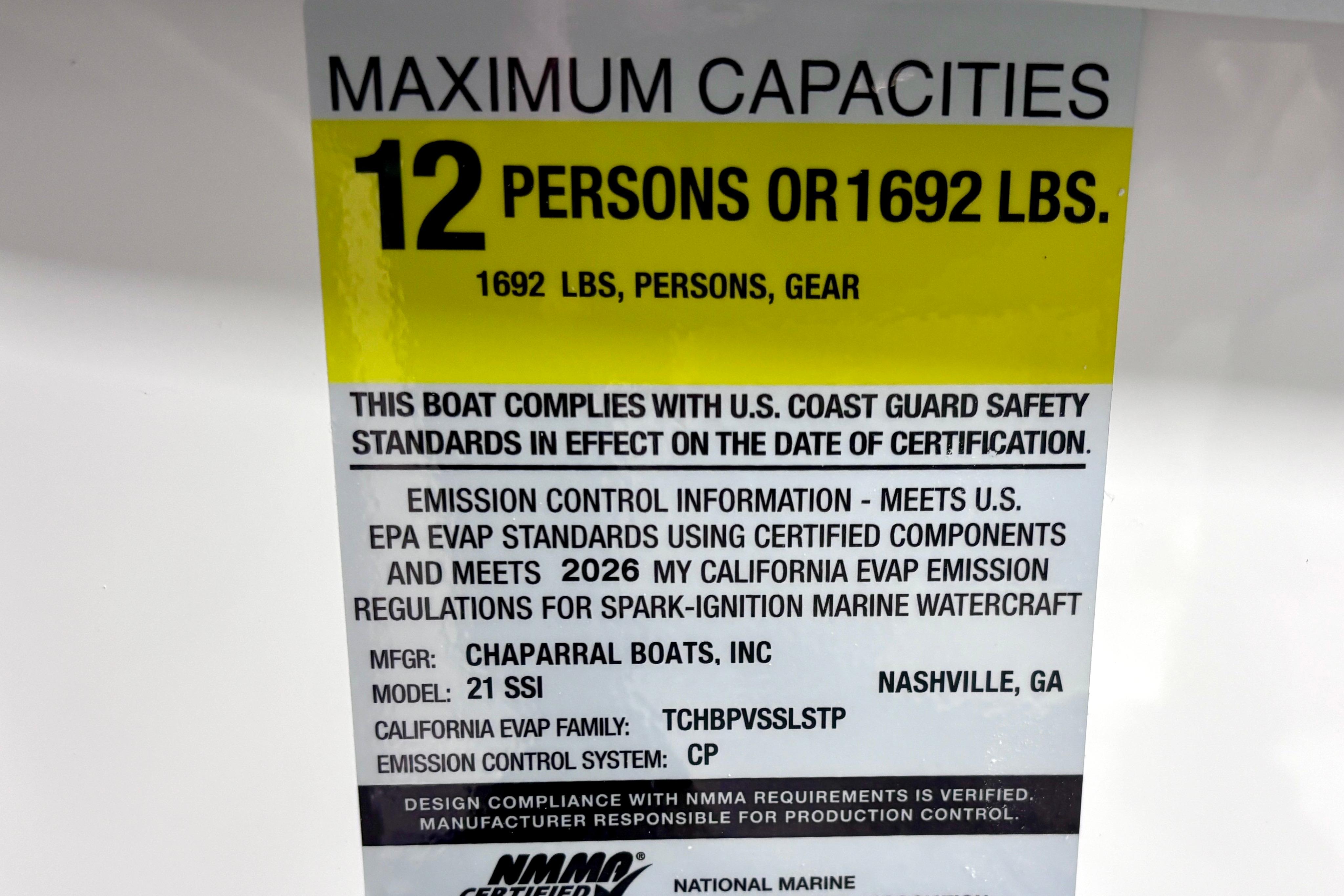 Capacity label for 2026 Chaparral 21 SSi boat, max 12 persons or 1692 lbs.