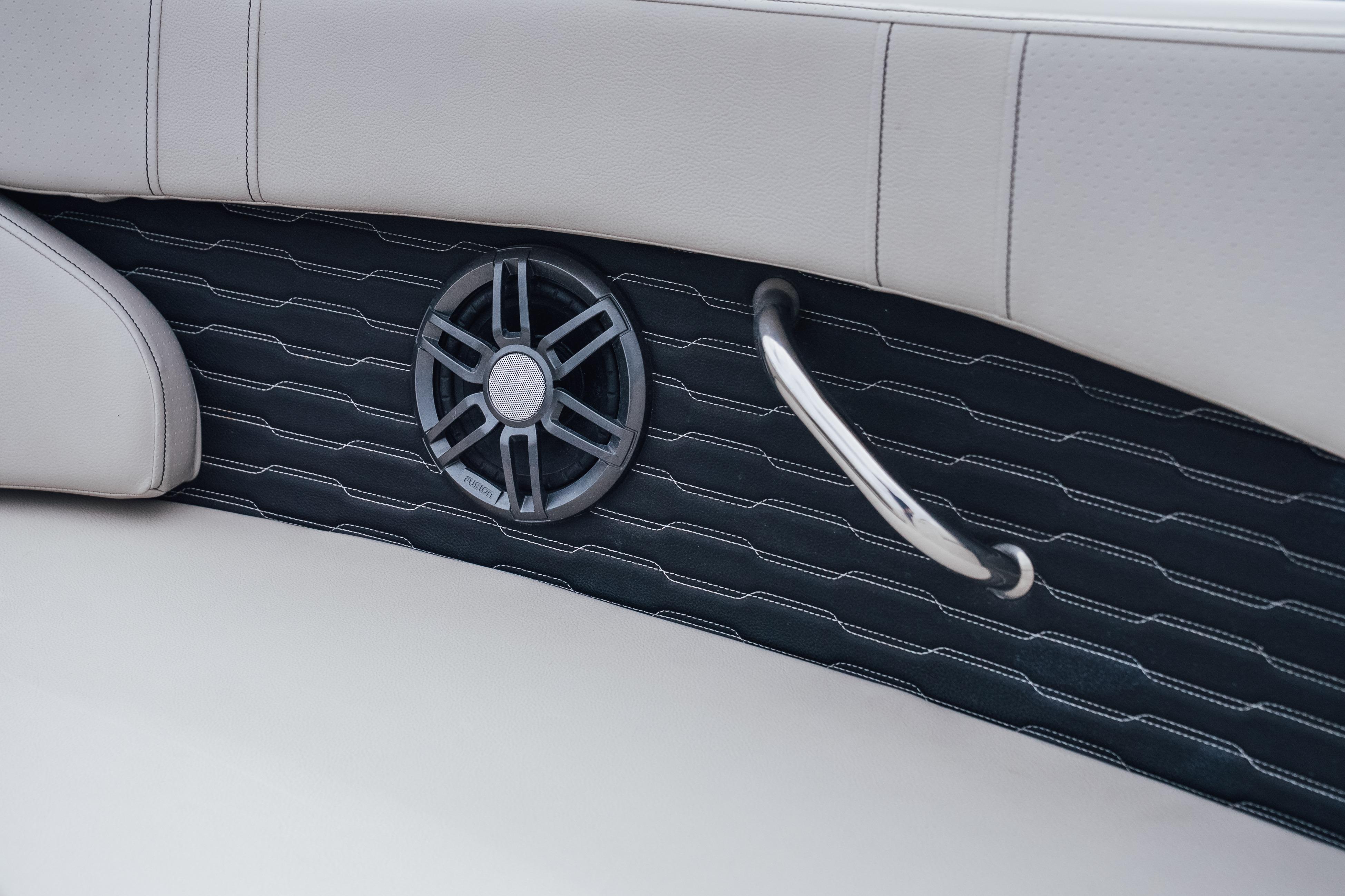 2023 Sea Ray SPX 230 interior detail with speaker and handle on cushioned panel.