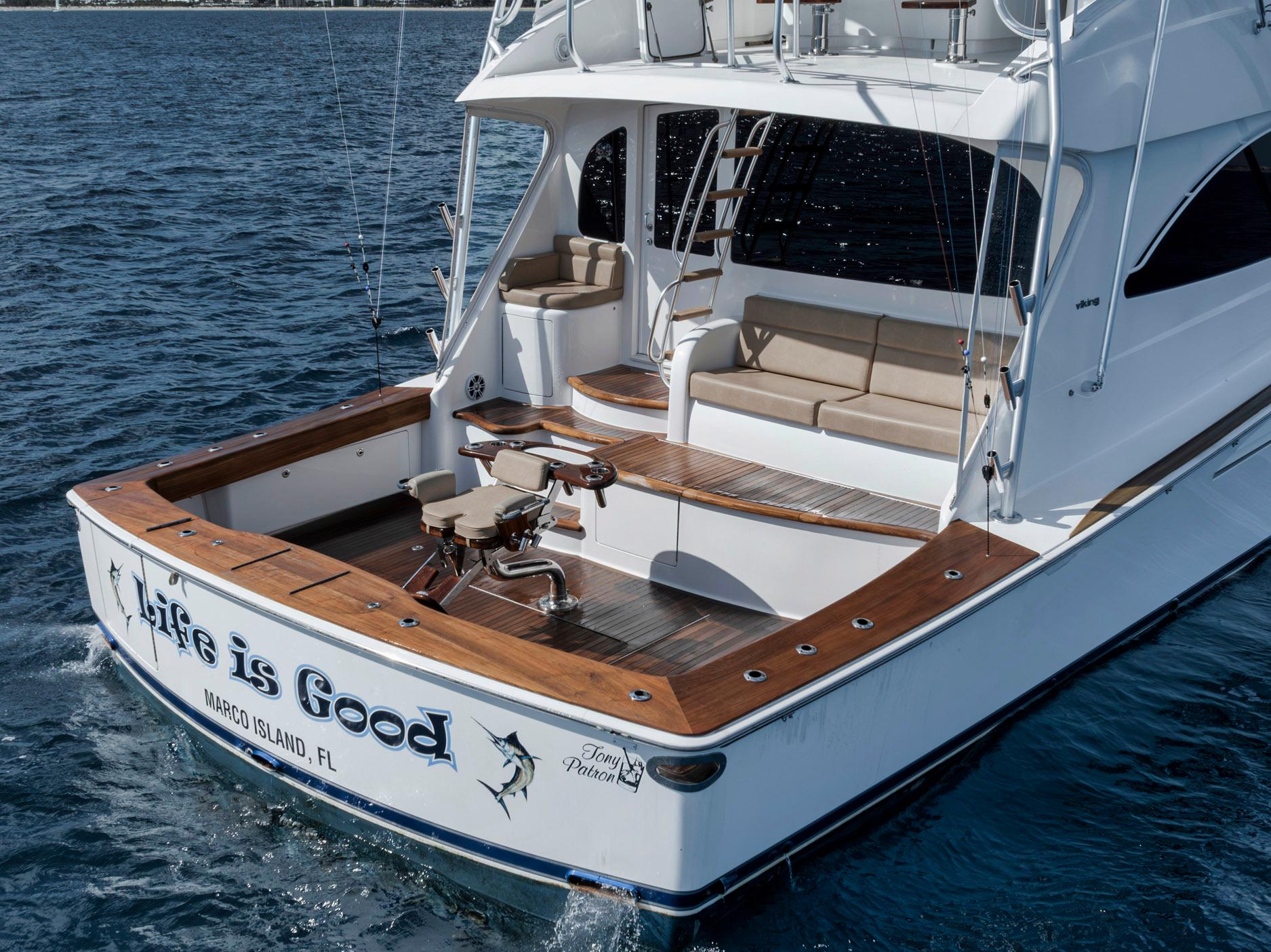 2015 Viking 70 Convertible yacht on water, featuring spacious deck and seating.