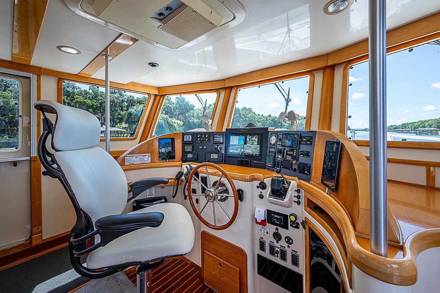 Luxurious helm of 2003 Magna Marine Nova Scotia 47 yacht with advanced navigation controls.