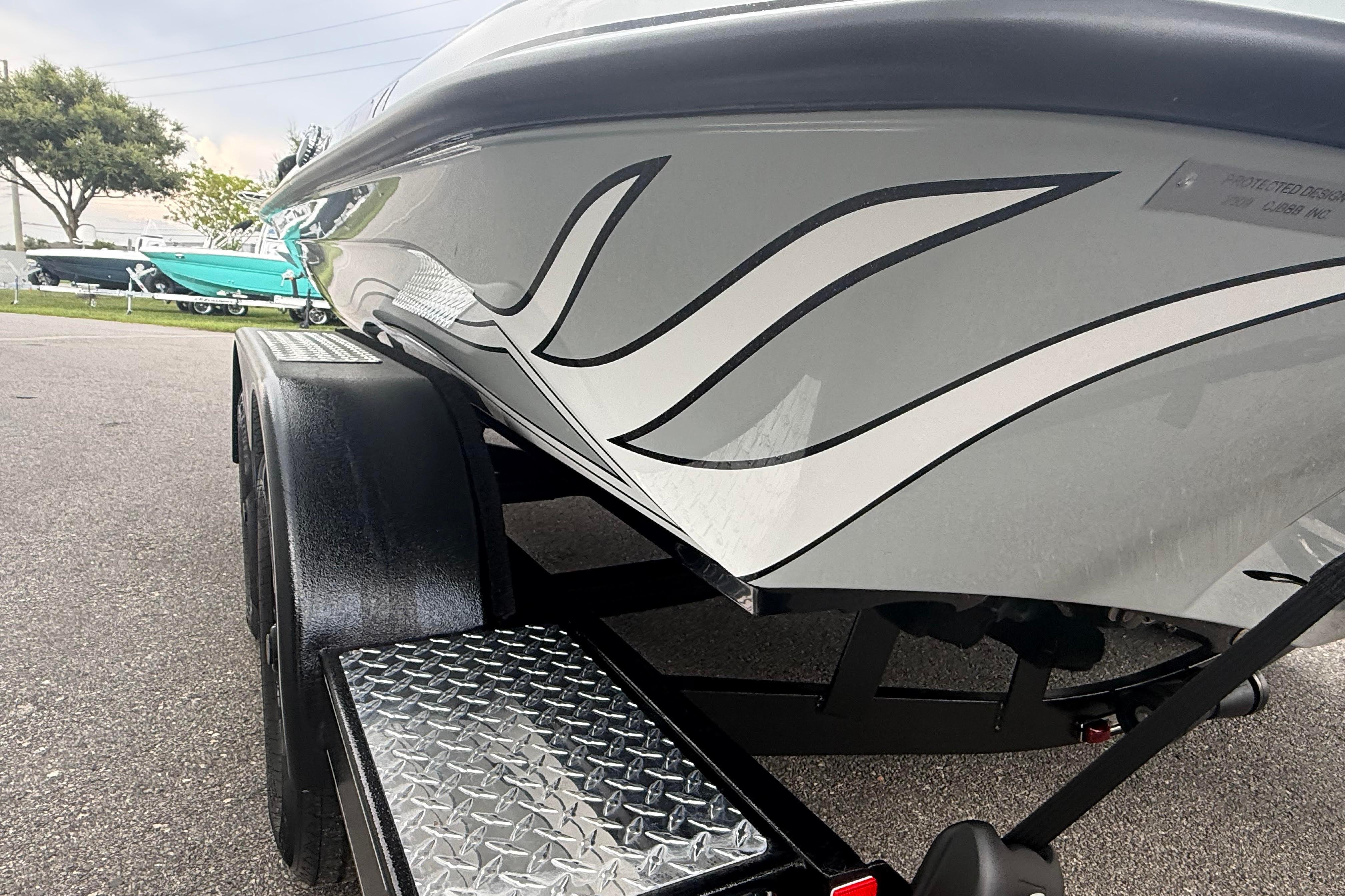 2027 Phoenix 921 Elite X II boat on trailer, showcasing sleek design and graphics.