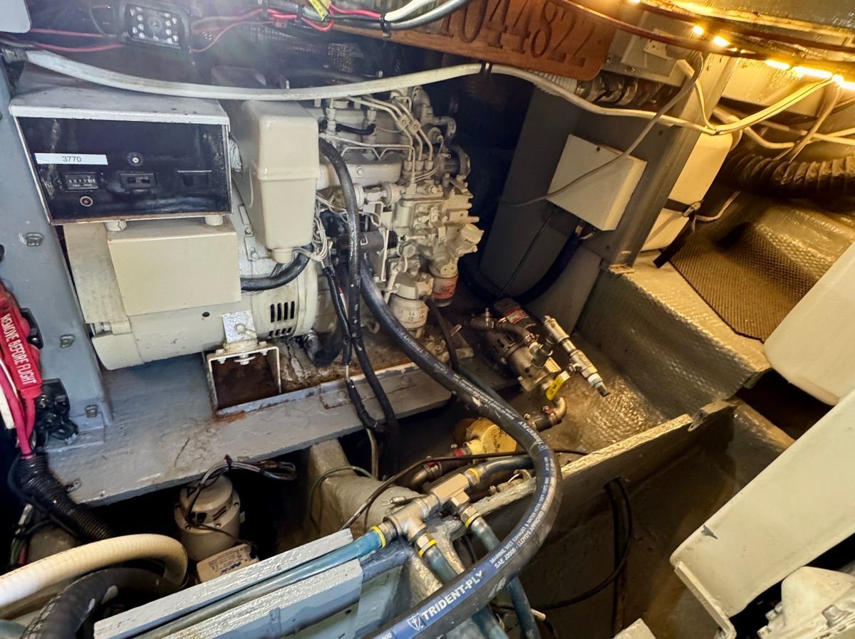 Engine room of a 1989 Luhrs 350 Tournament with visible hoses and cables.