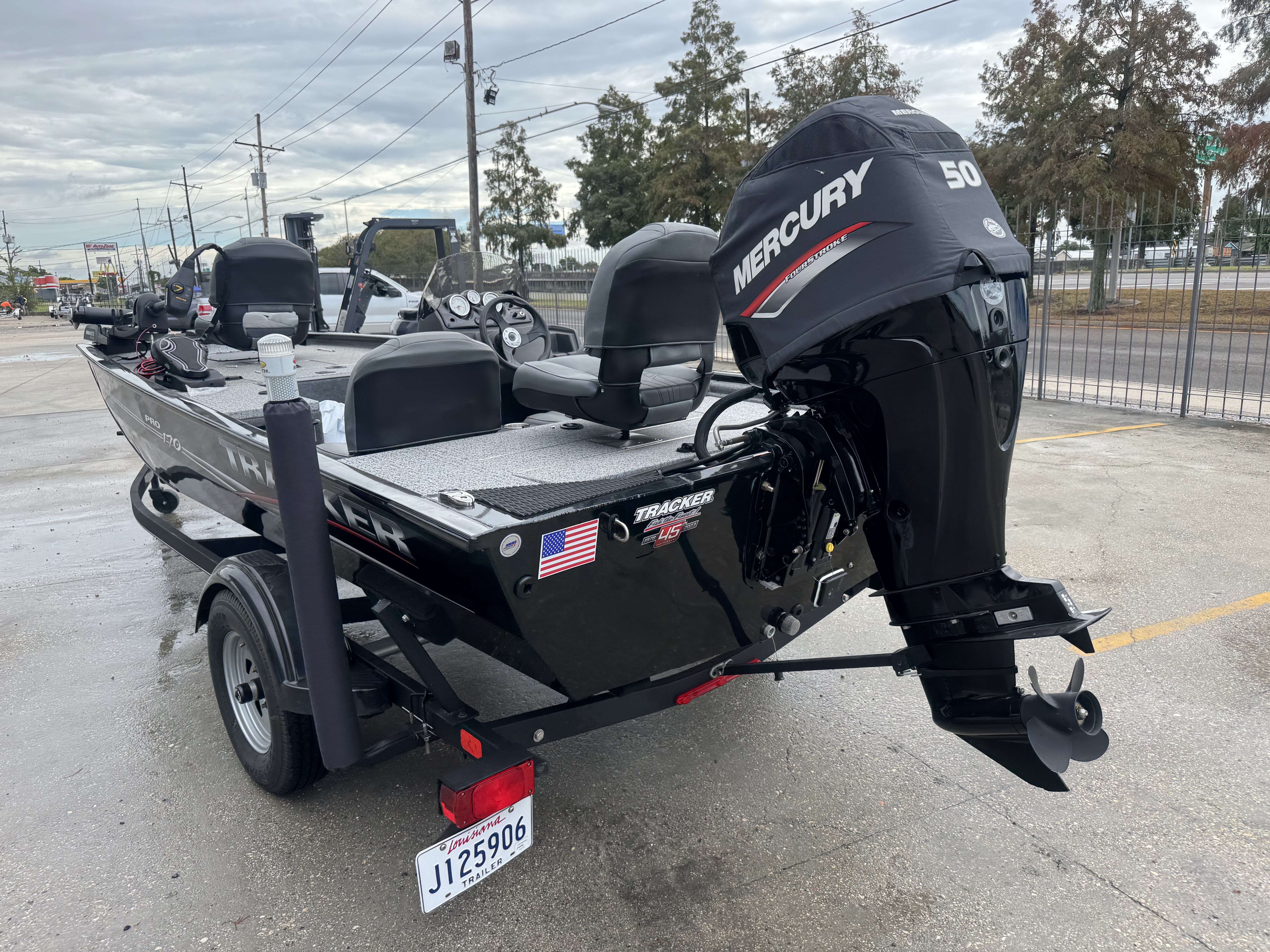 2024 Tracker Pro 170 boat with Mercury 50 engine, parked outdoors.