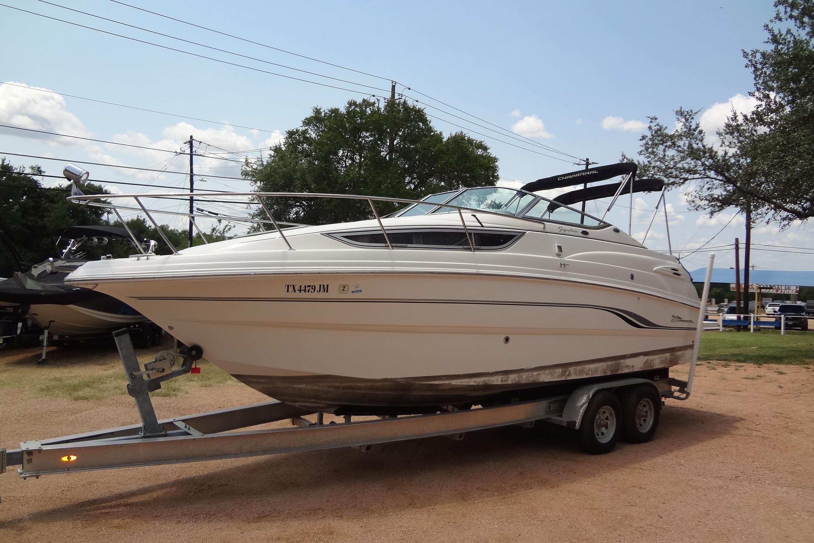 2000 Chaparral Signature 260 boat on trailer, parked outdoors.