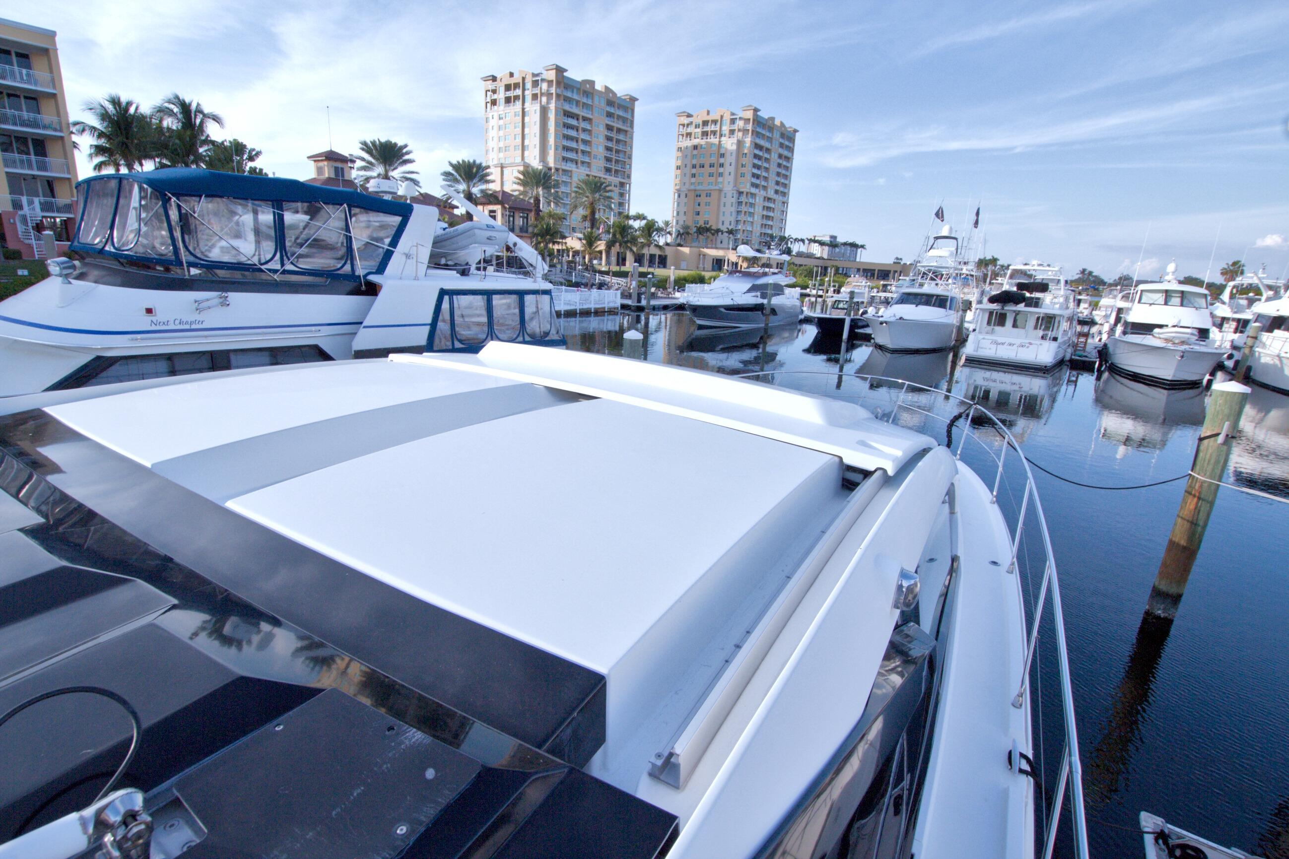 2019 Beneteau Gran Turismo 50 yacht docked in a marina with surrounding boats.