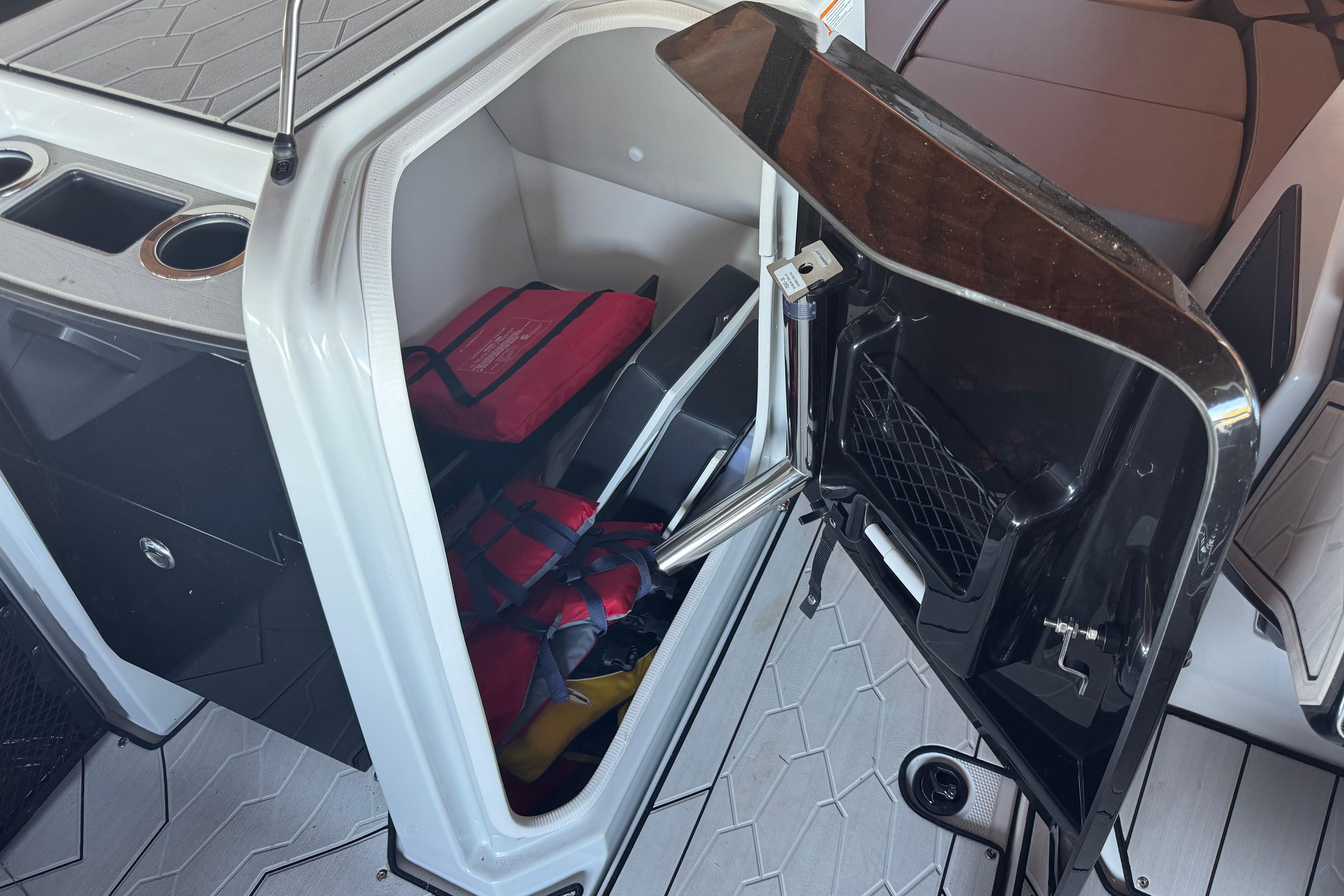 2024 Yamaha Boats 255XE storage compartment with life jackets and accessories.