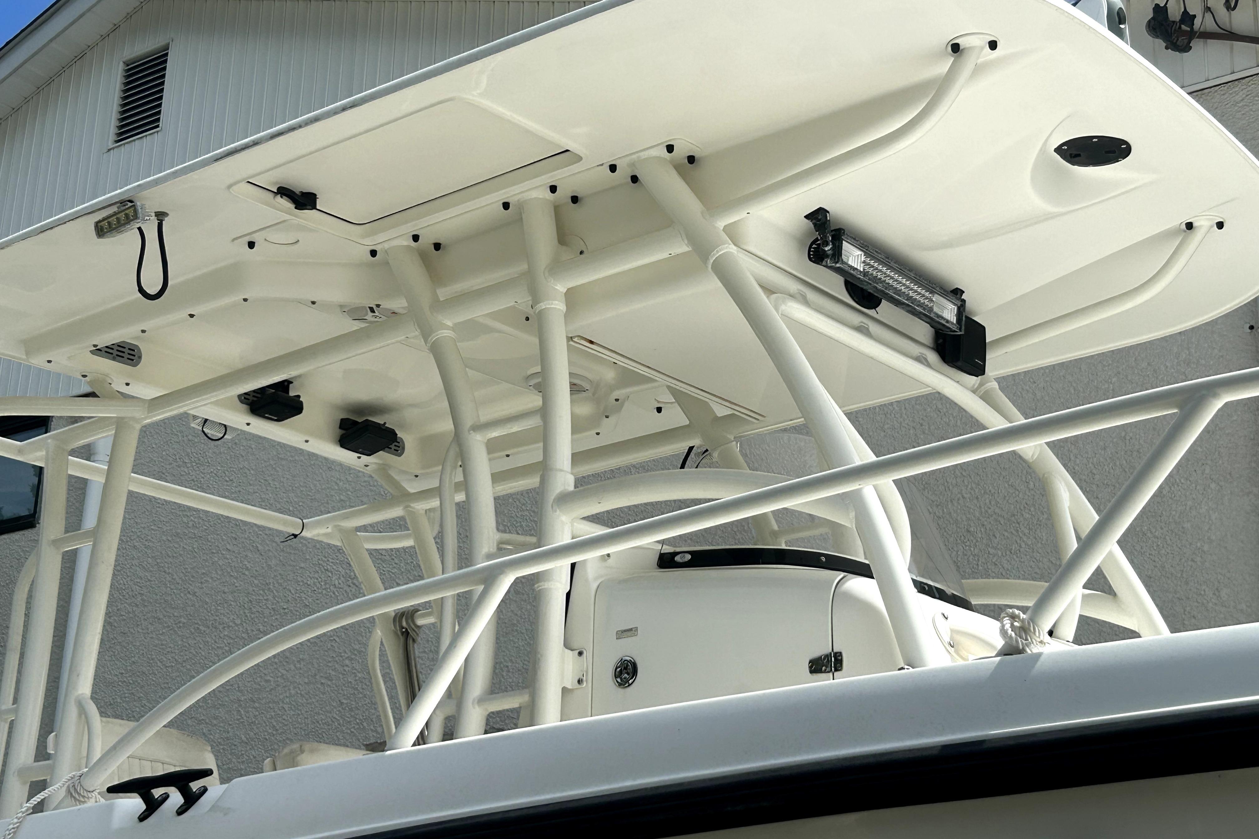 Boston Whaler 320 Outrage 2012 boat with sturdy T-top and mounted equipment.
