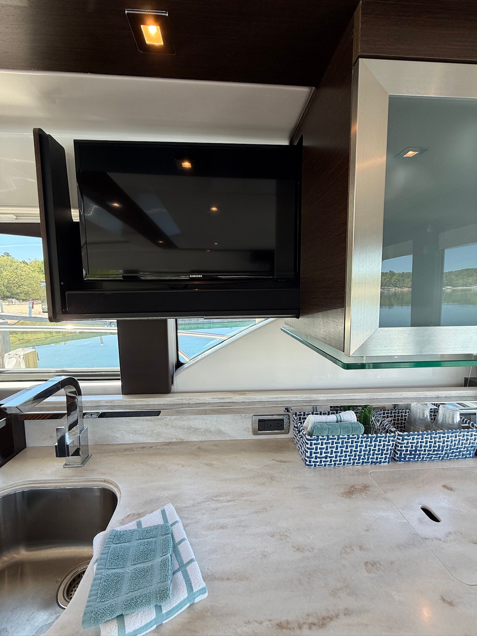Interior of the 2017 Tiara Yachts C44 Coupe featuring a modern kitchen and TV.