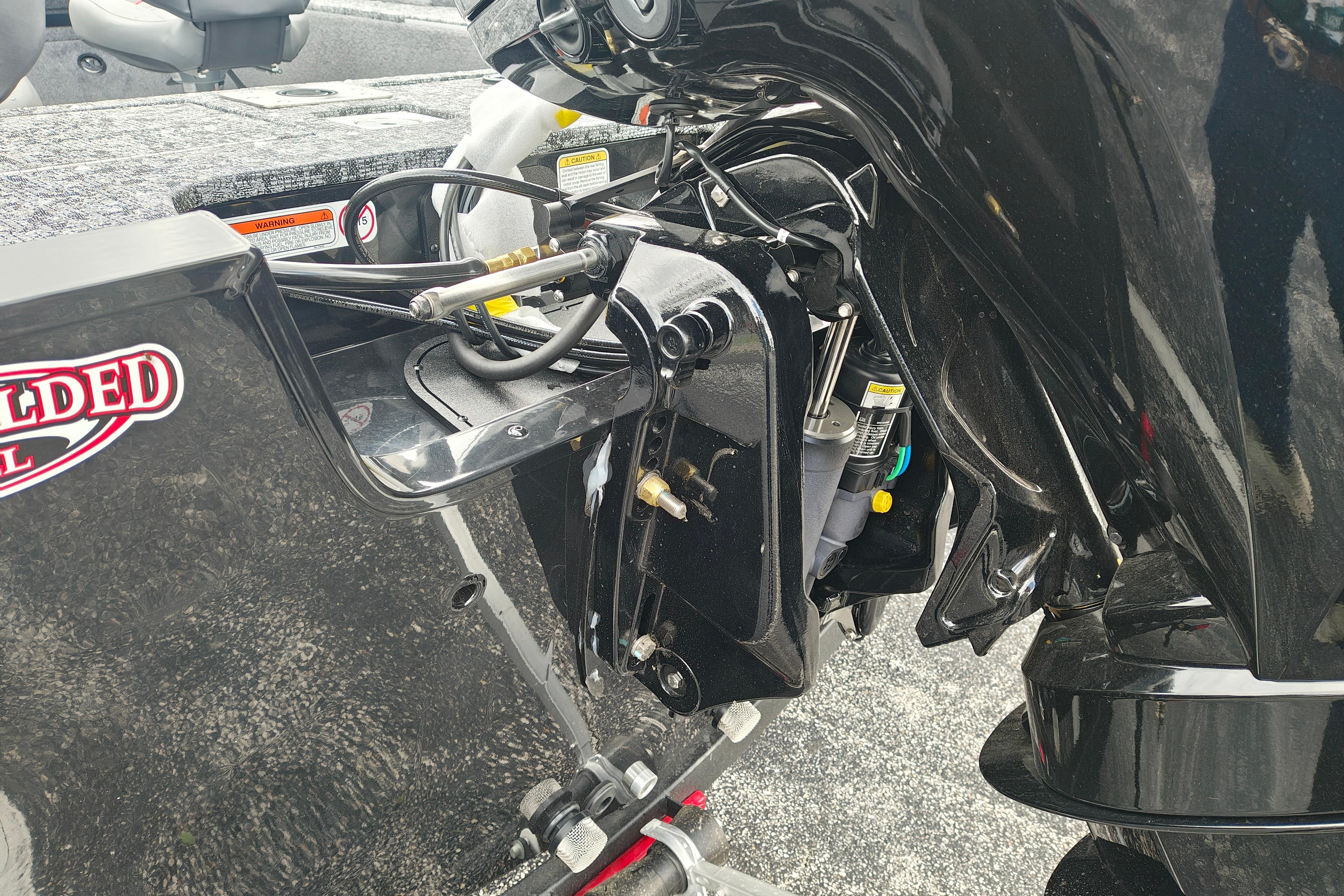 2026 Tracker Pro Guide V-175 WT boat engine detail, showcasing hydraulic components and sleek design.