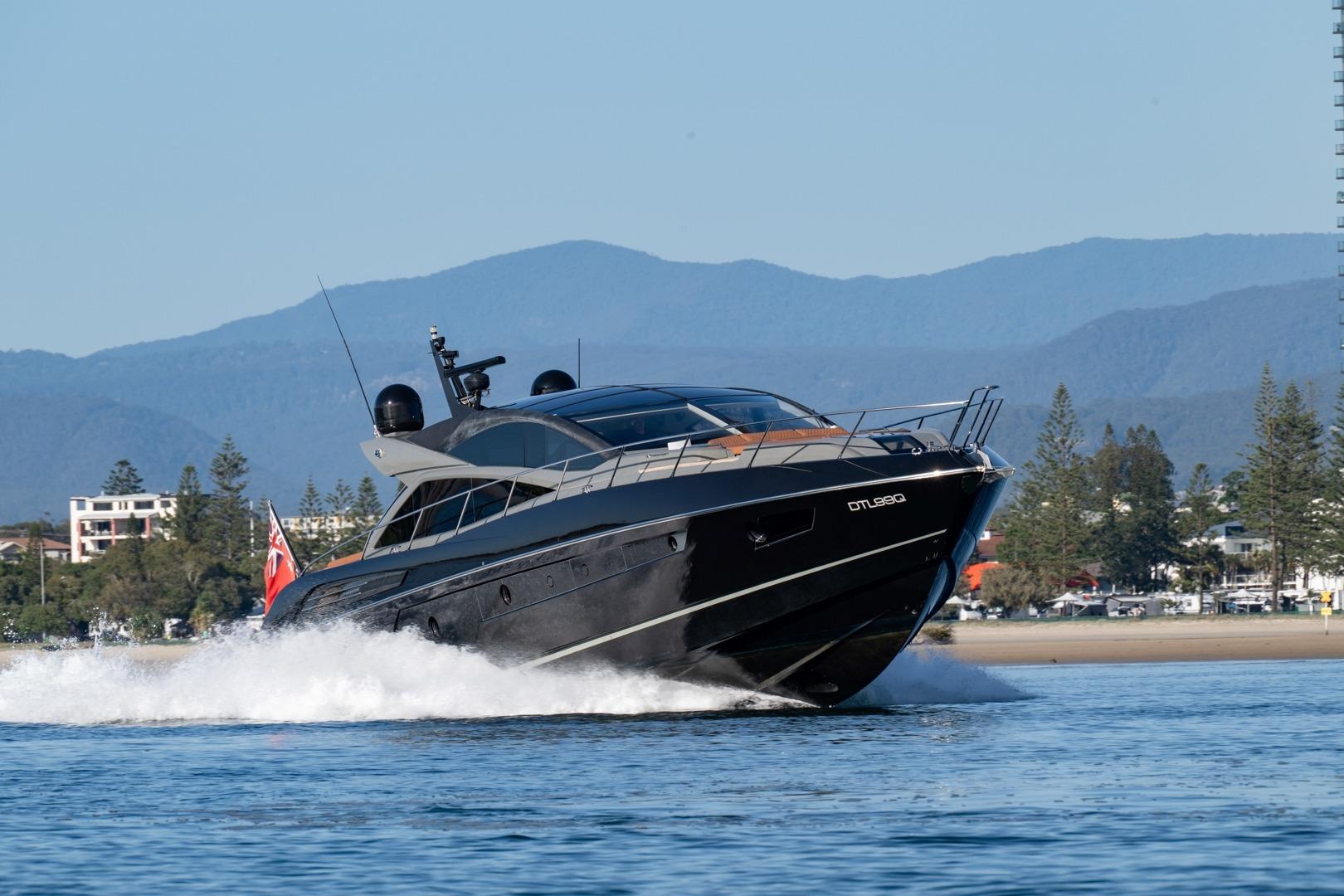 2013 Sunseeker Predator 68 yacht cruising on water with scenic mountain backdrop.