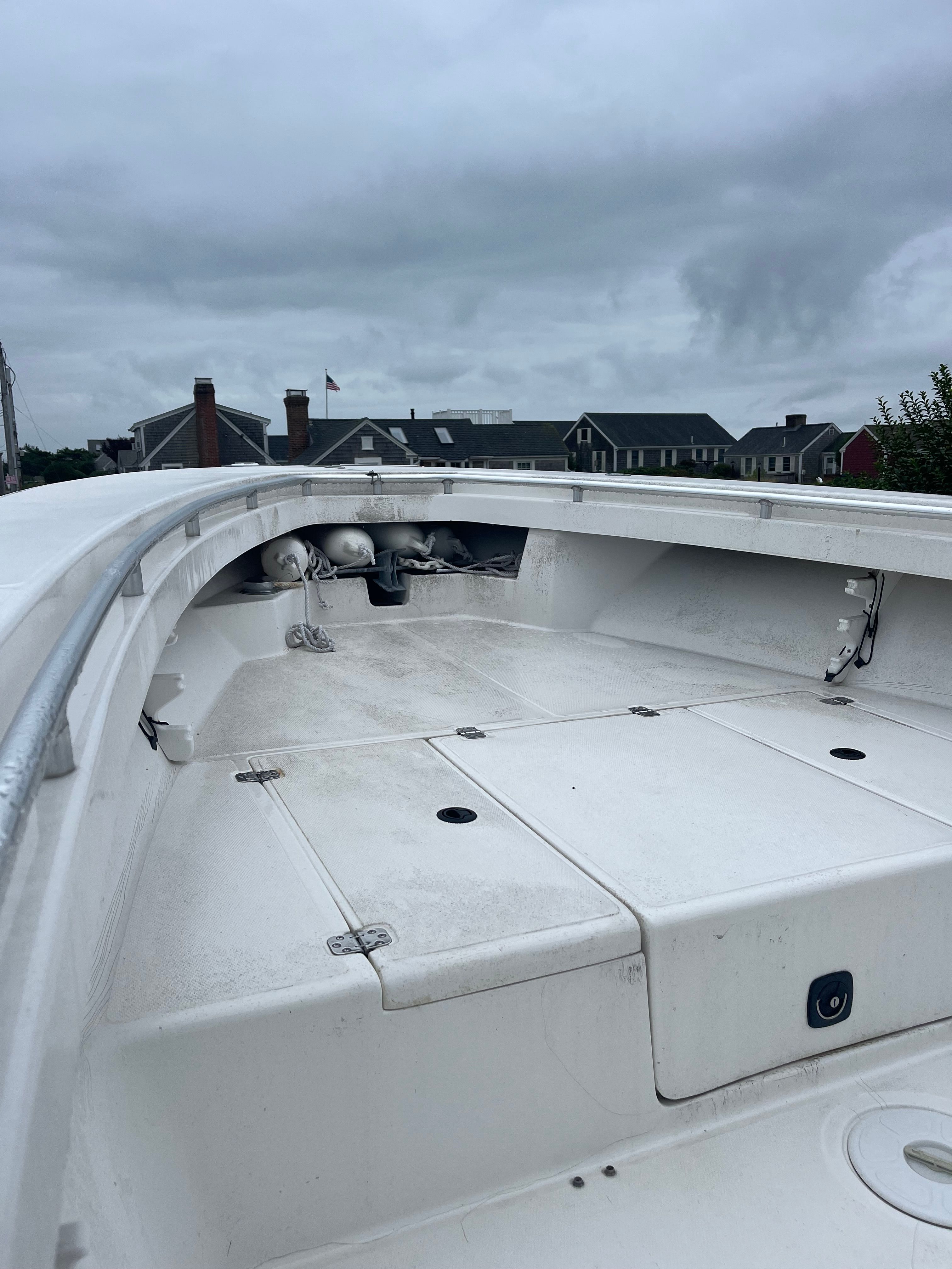2001 SeaCraft boat, model SXCRB730H001, on calm water near houses.