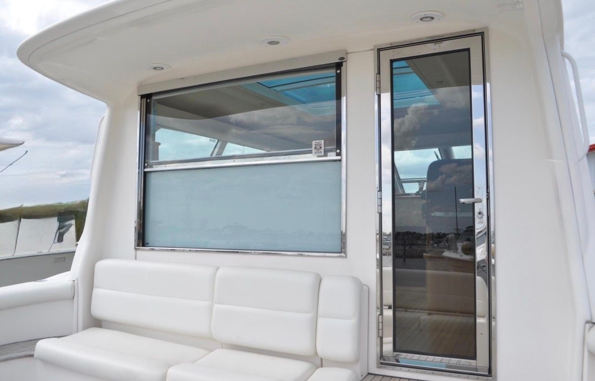 The 2005 Tiara Yachts 5200 Sovran features a modern exterior design with white cushioned seating.