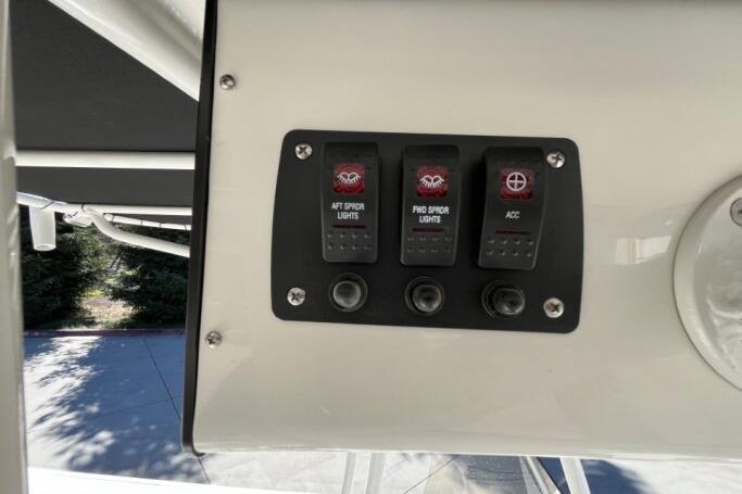 Control panel of 2025 Mako 214 Center Console with switches for lights and accessories.