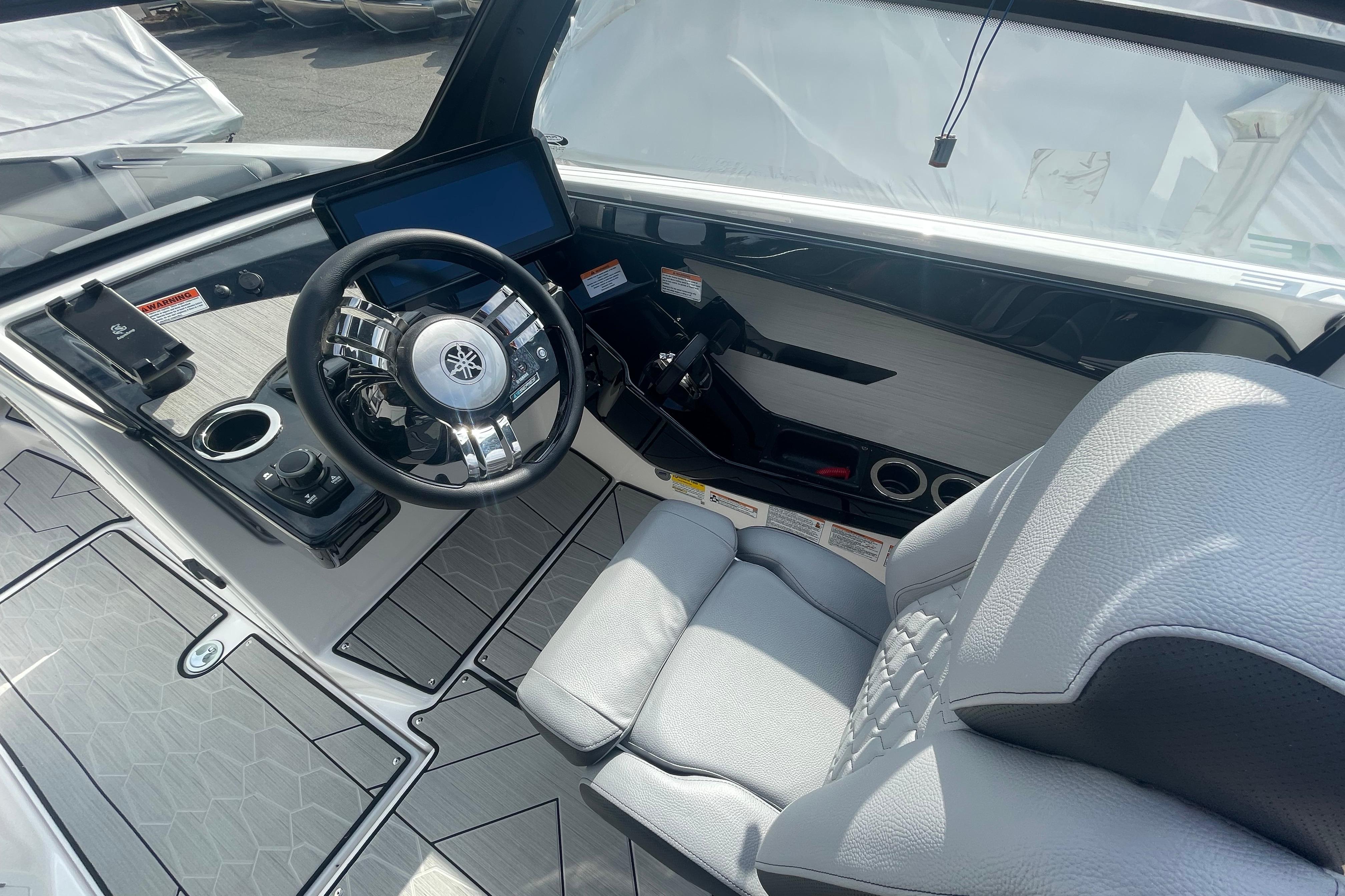 Interior view of 2026 Yamaha Boats 222XD, featuring sleek steering and modern controls.