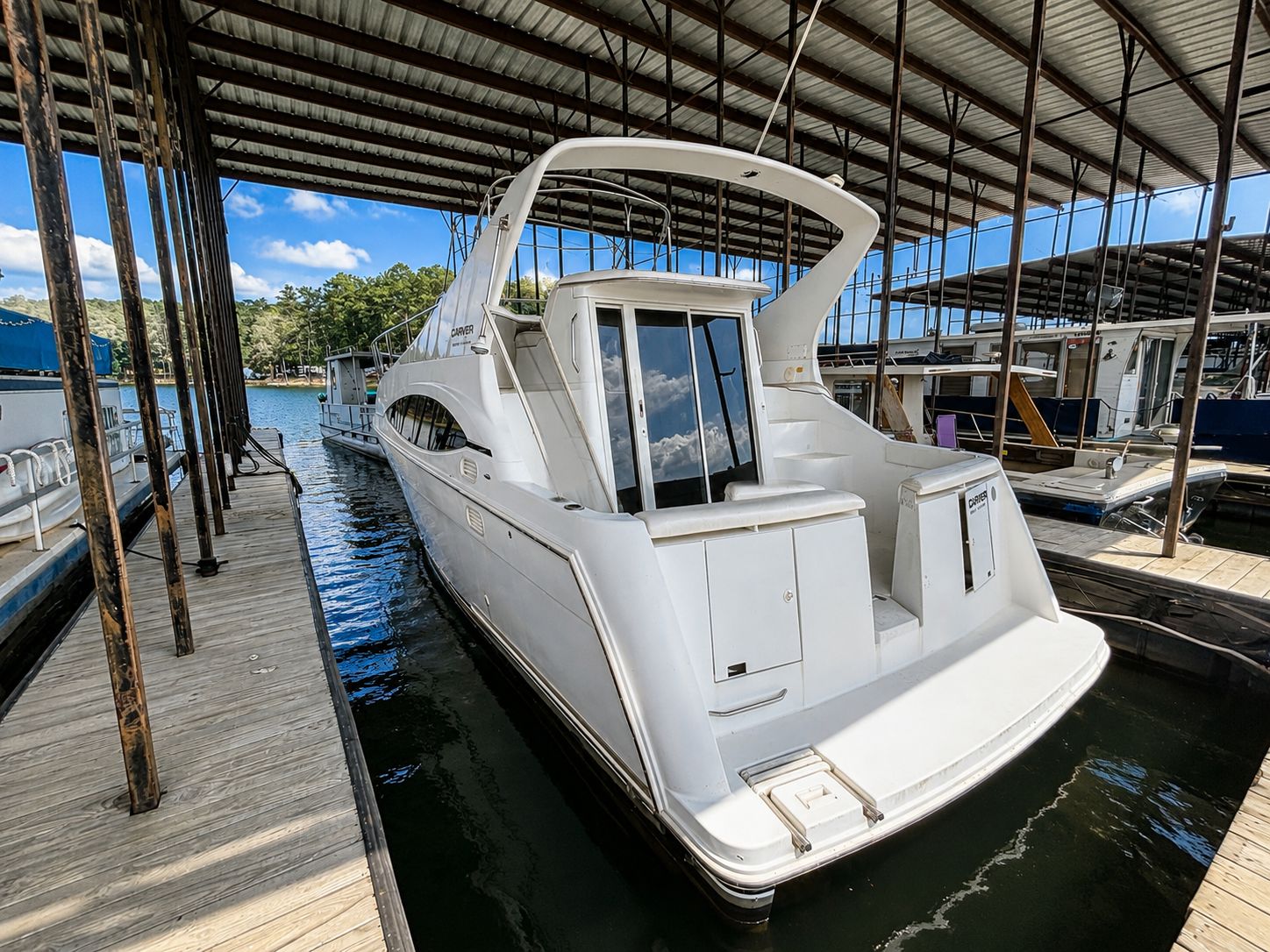 A 2001 Carver 350 Mariner docked in a covered marina.