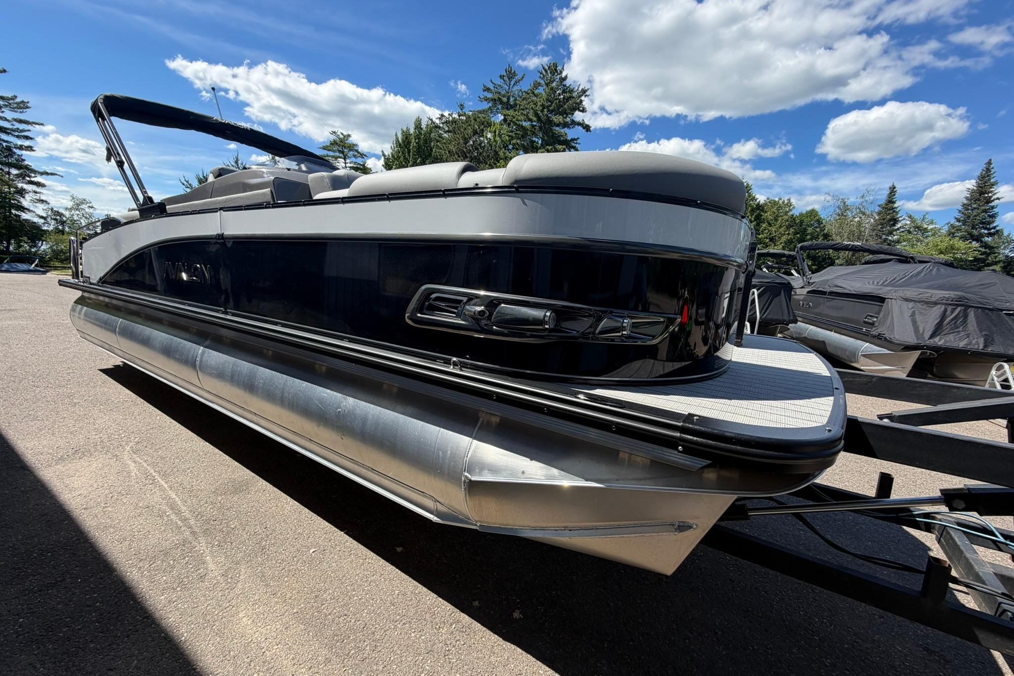 2026 Avalon Catalina Quad Lounge Shift pontoon boat on trailer under blue sky.