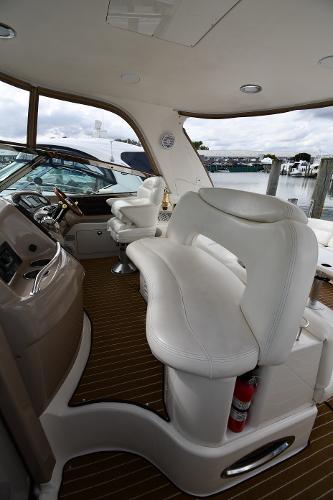 2003 Sea Ray 460 Sundancer yacht interior with white seating and wooden flooring.